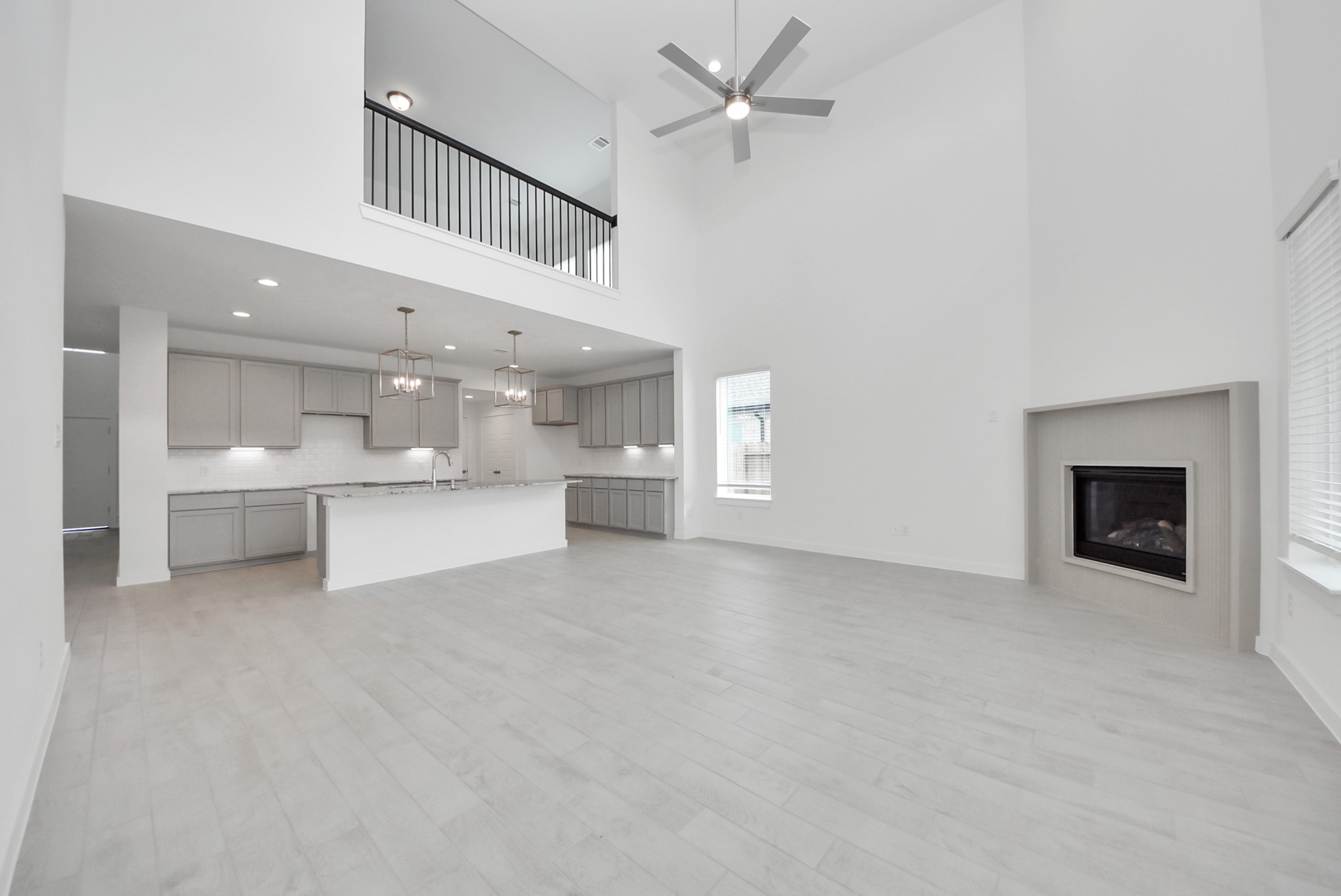 Embrace the warmth and comfort of this inviting family room, flooded with natural light that showcases breathtaking views of the community lake through expansive windows. The premium tile flooring adds a touch of luxury to the space, creating the perfect setting for relaxing moments and cherished gatherings with loved ones