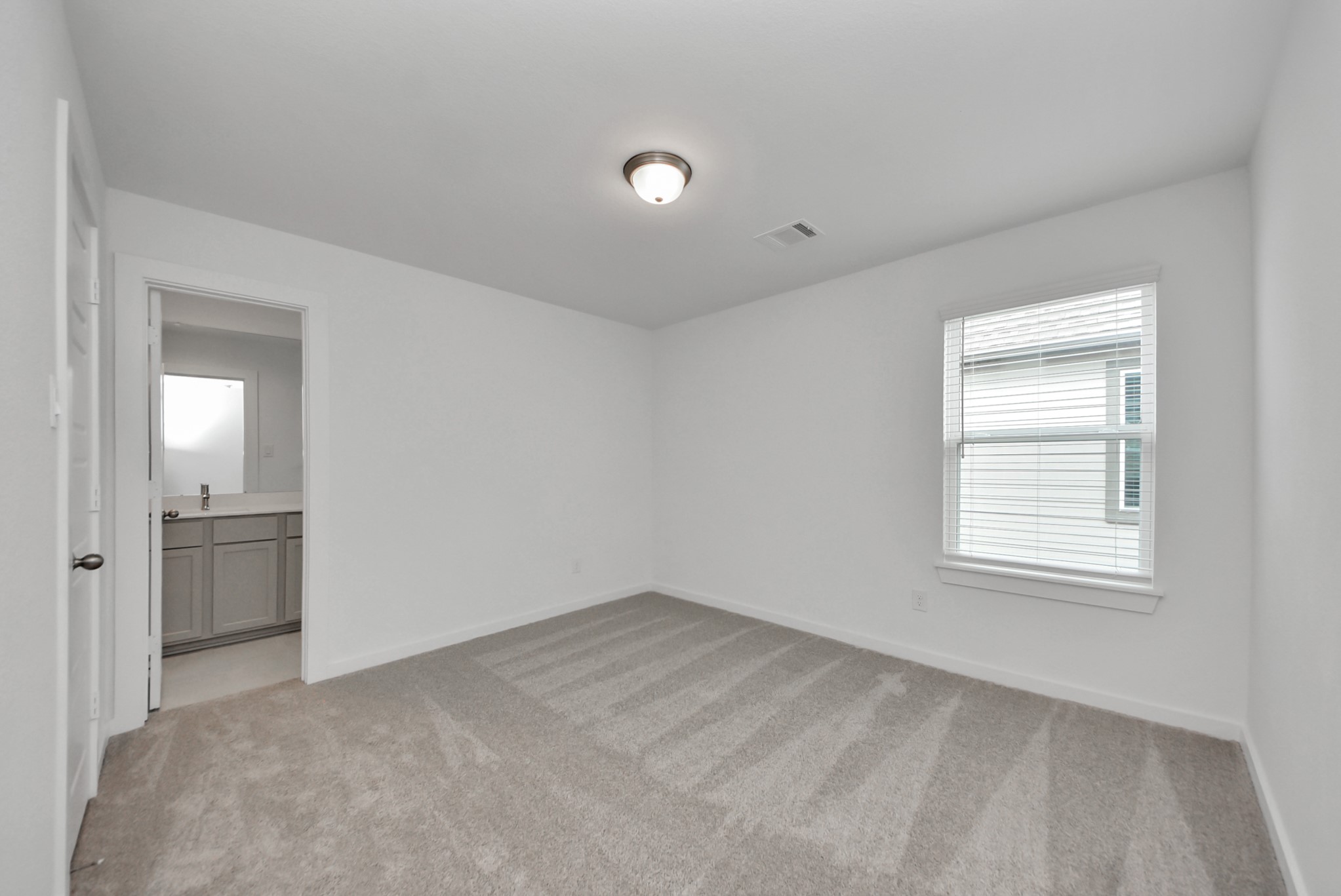 Generously sized secondary bedrooms featuring spacious closets, soft and inviting carpeting underfoot, large windows allowing plenty of natural light, and the added touch of privacy blinds for your personal retreat.