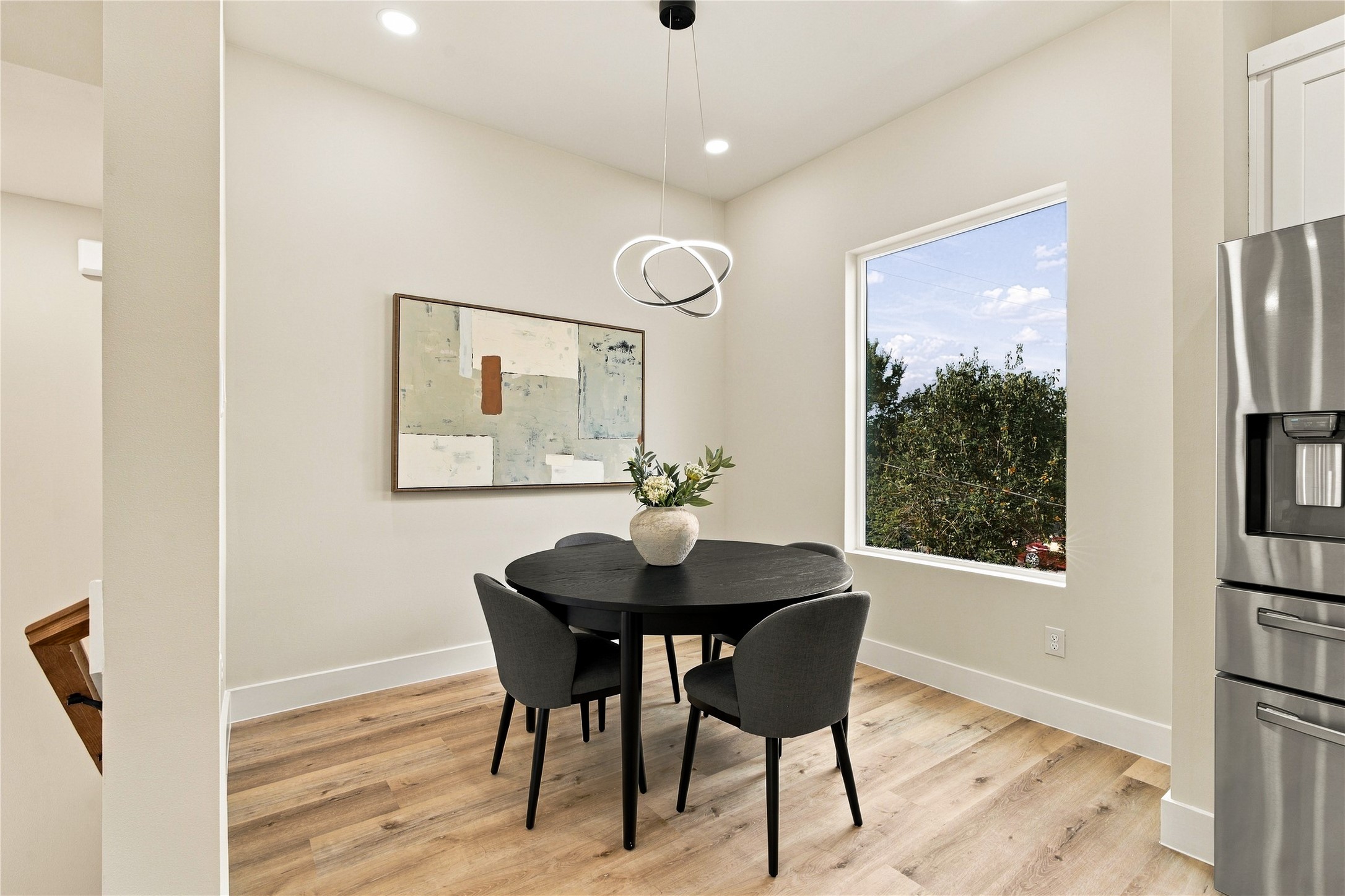 Intimate dining nook  sunny corner framed by green tree views for memorable dinners and morning tea.