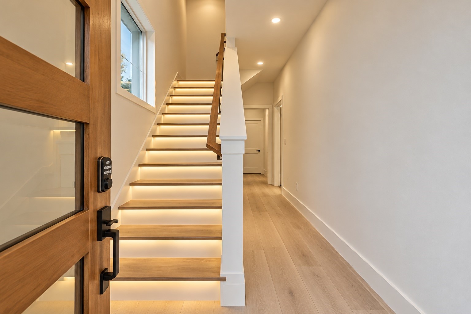 Grand entrance stair  natural wood treads and keyless smart lock bring instant elegance to your daily entry.