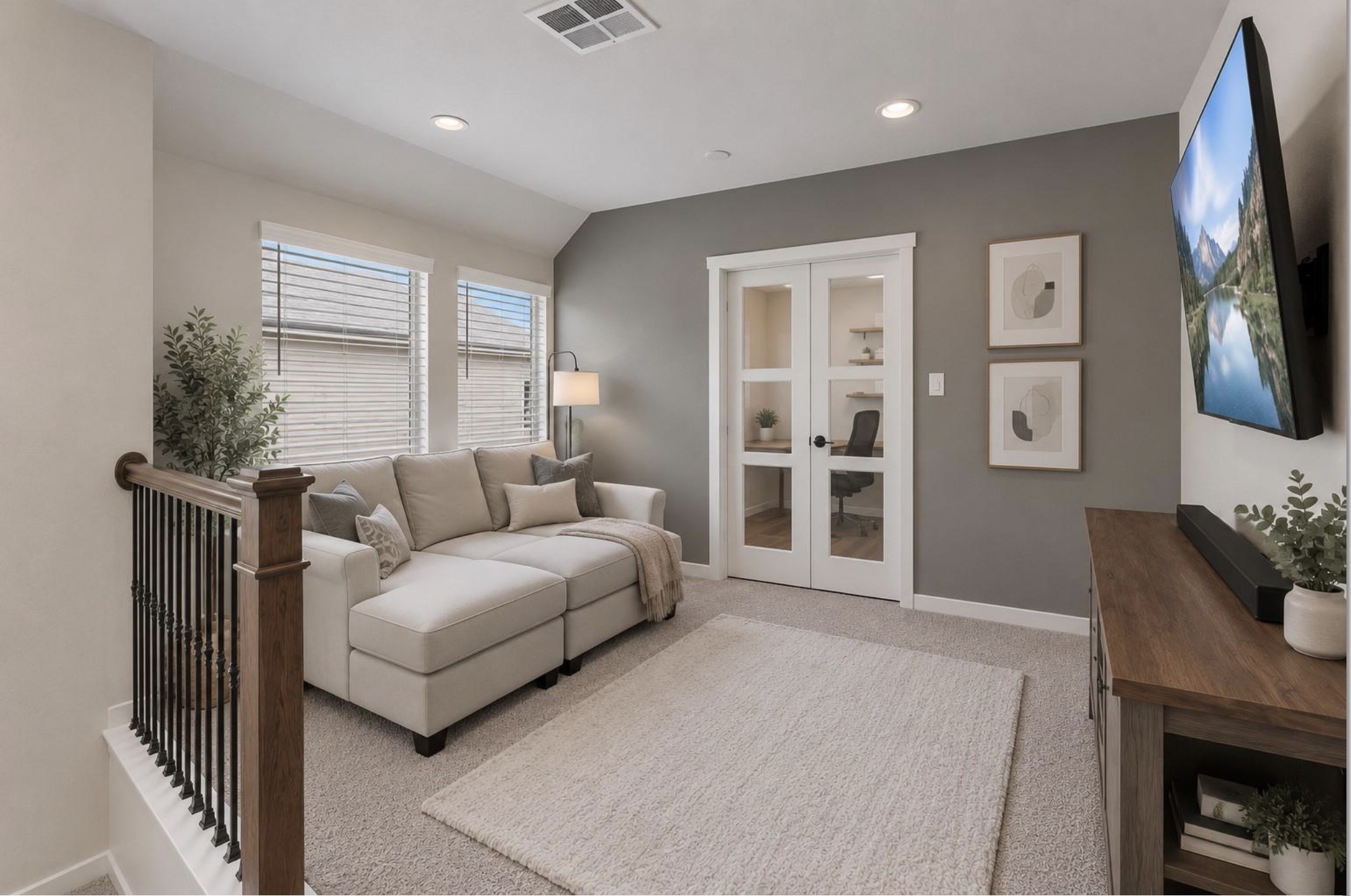 Additional view of the upstairs game room, featuring comfortable carpeting, a ceiling fan, and French doors that help define this flexible living space.