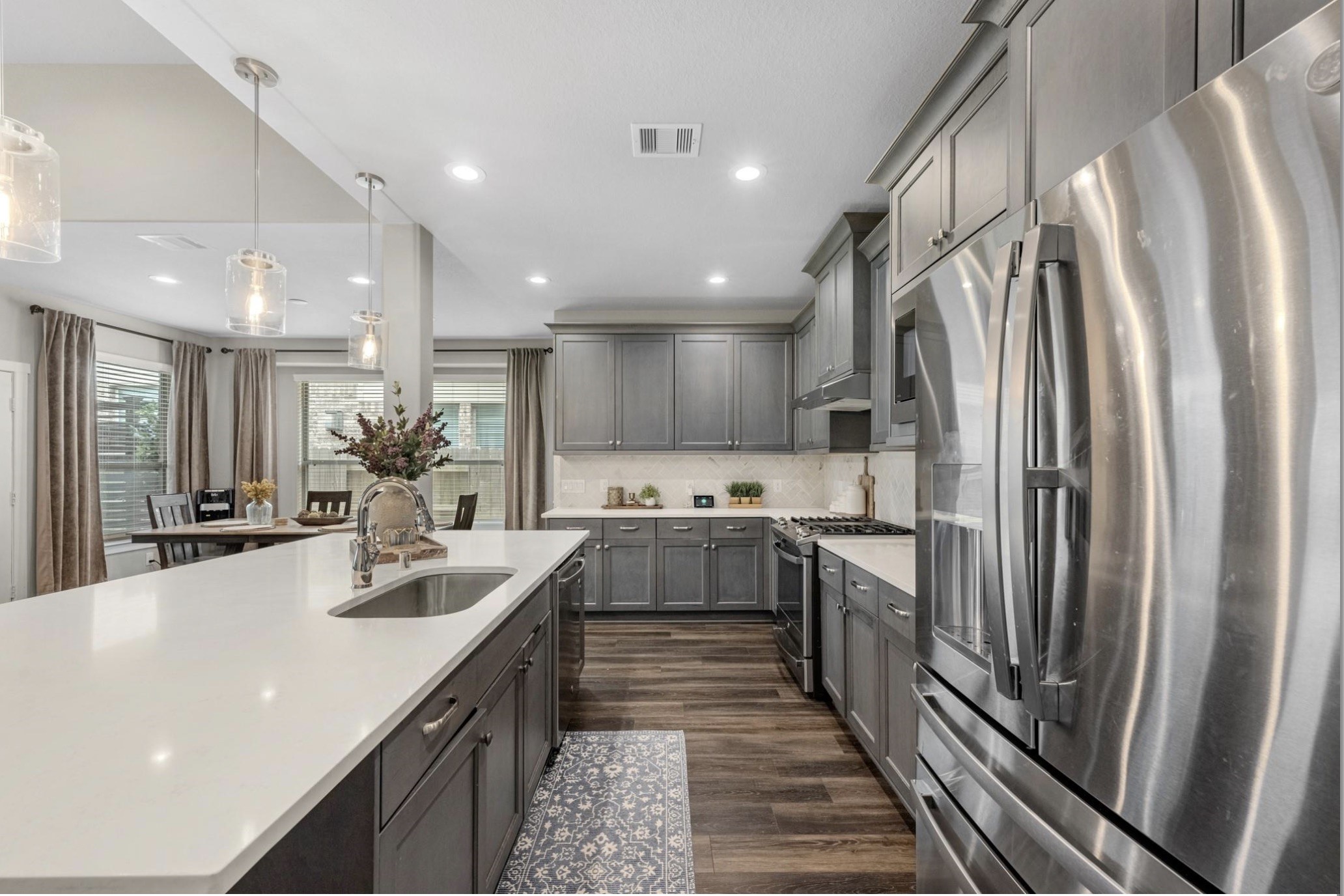 Well-appointed kitchen with stainless steel appliances, gas cooktop, generous counter space, and a functional layout that opens seamlessly to the main living areas.