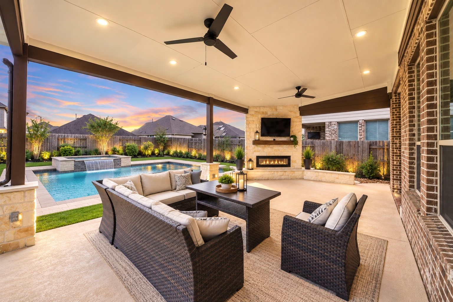 Beautiful evening view of the covered patio, showcasing the inviting outdoor fireplace, spacious seating area, and relaxing backyard atmosphere. VS pool gives you an idea of what your patio would look like in the future.