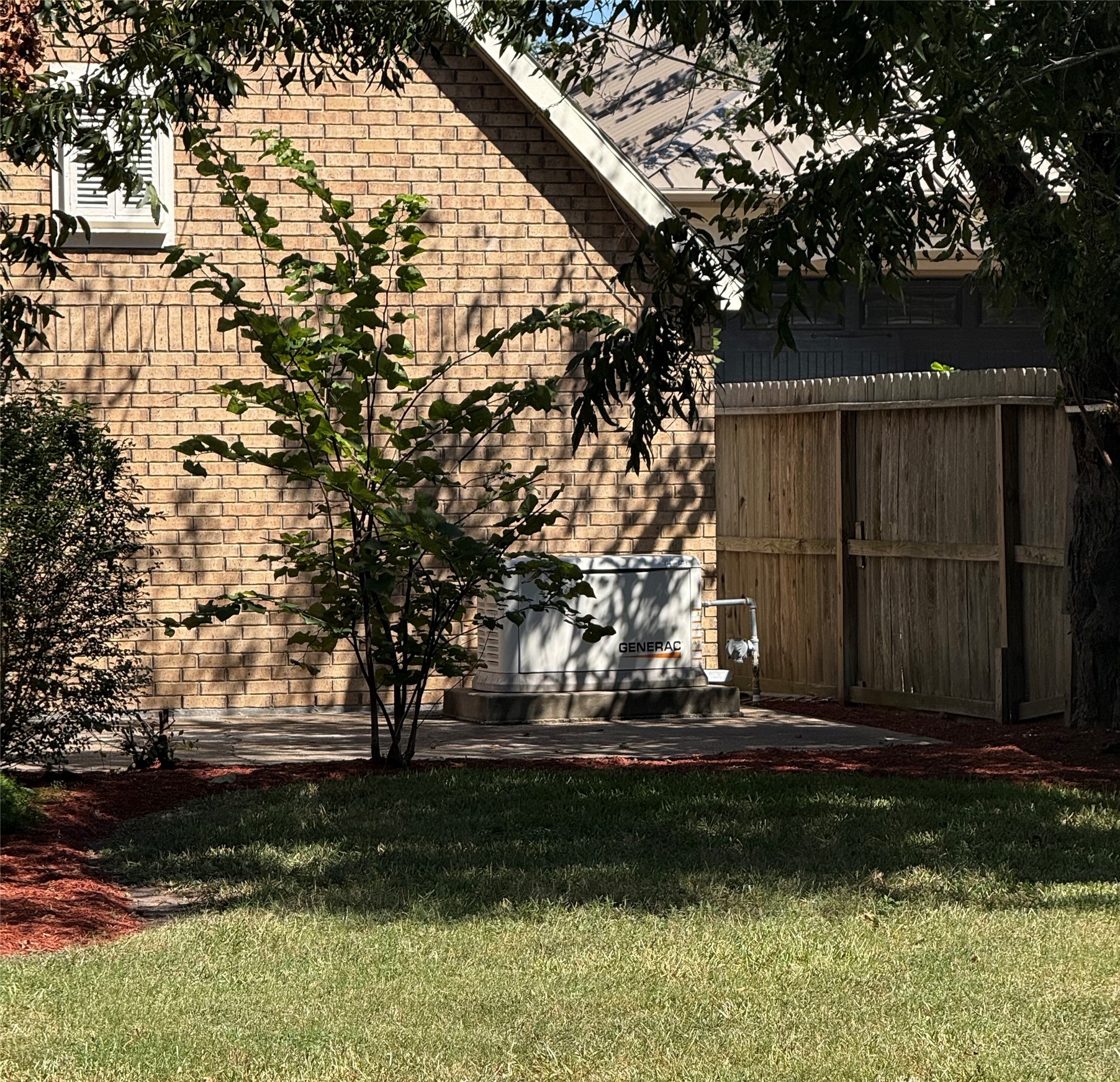 Generac whole house generator by the extra parking spot off the driveway.