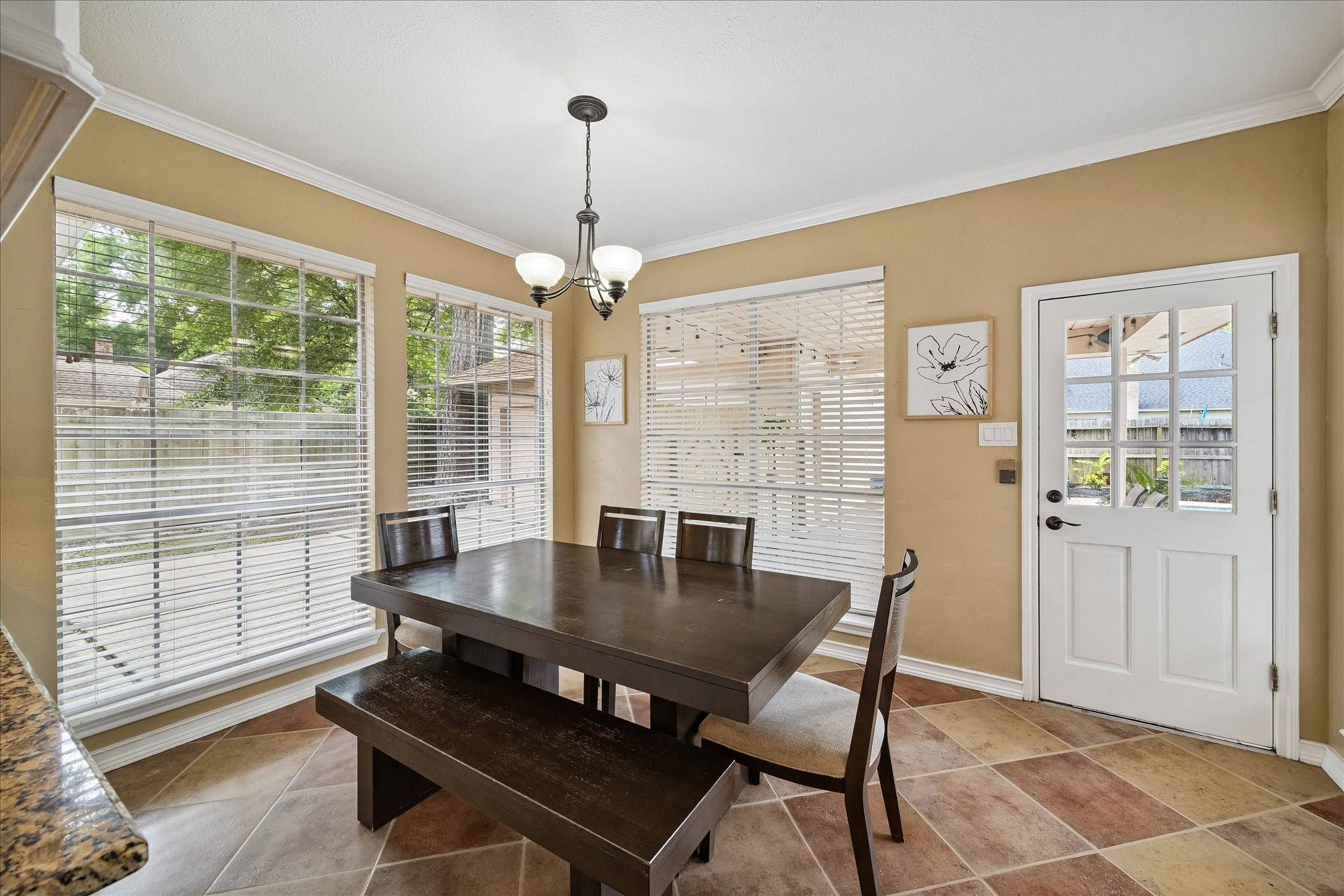 This huge dining area is hosting a very large table.  Look at all the light here.