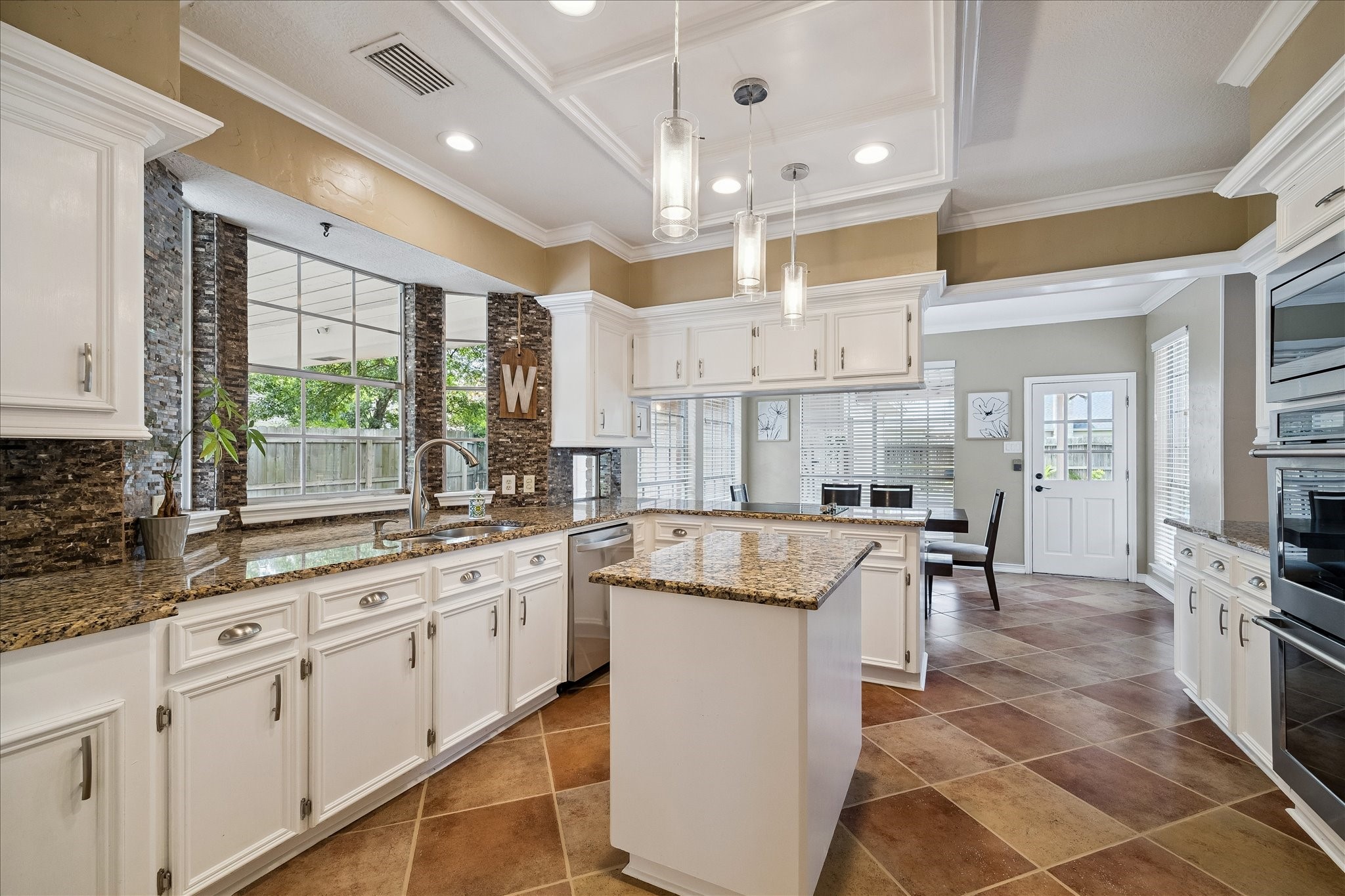 Look at all the counte space filled with light from large windows.