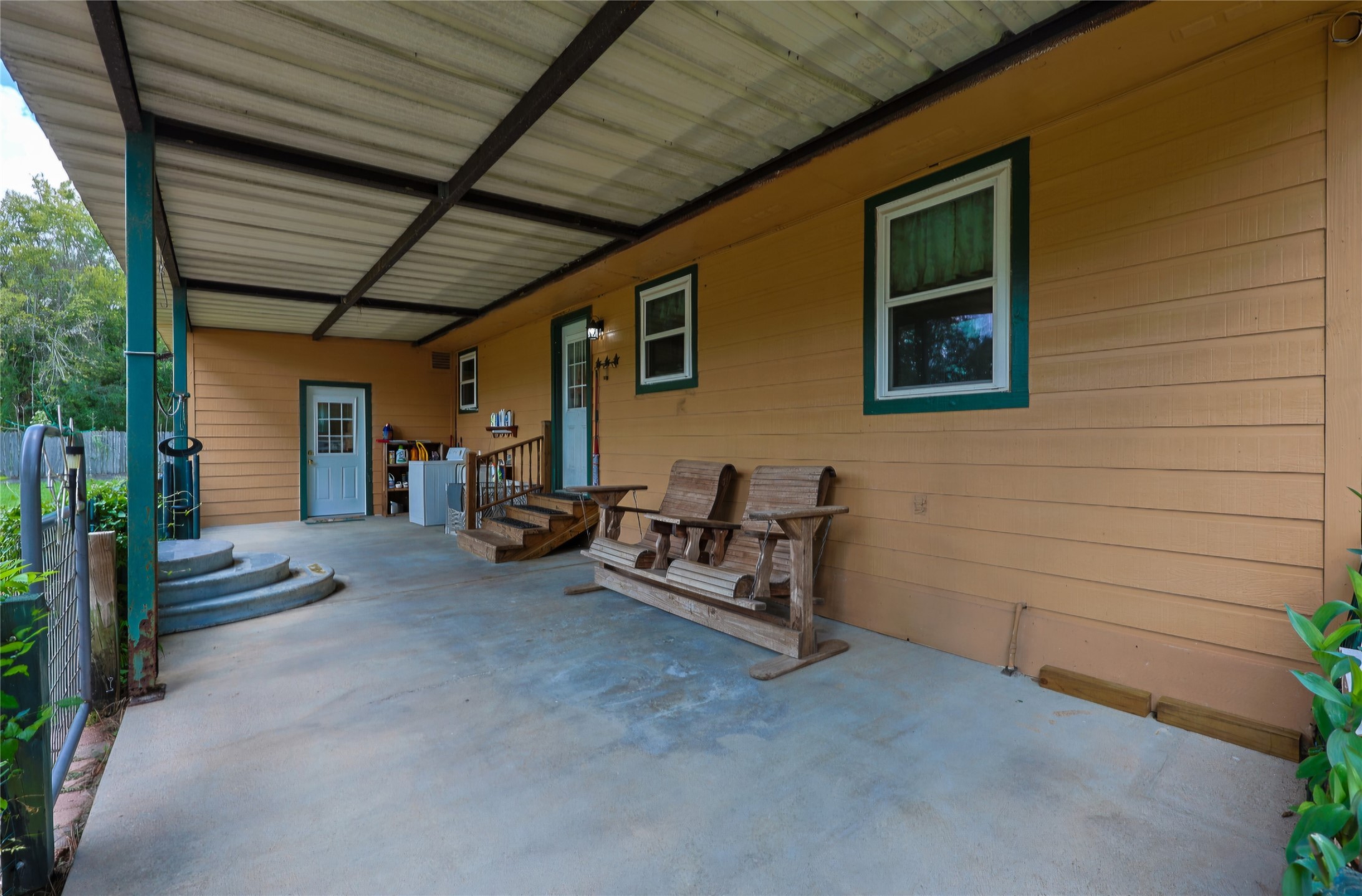 Back Patio with access to kitchen/mud room, and 2nd door to Primary Bd rm.