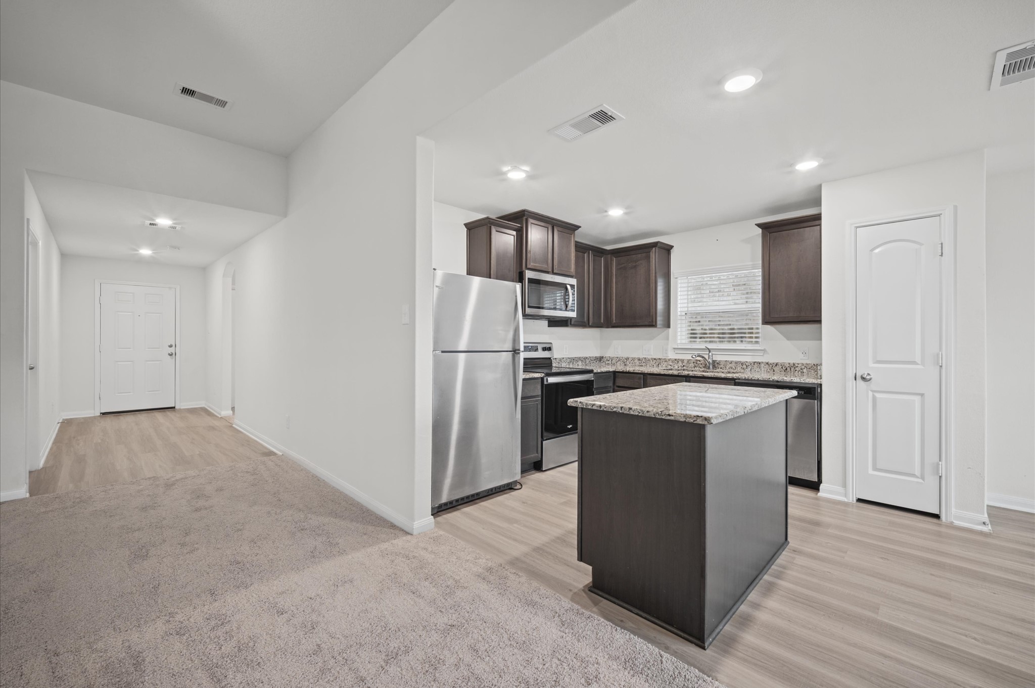 Solid surface entry way and brand new carpet in the family room. Large kitchen with a useable Island. Refrigerator is included.
