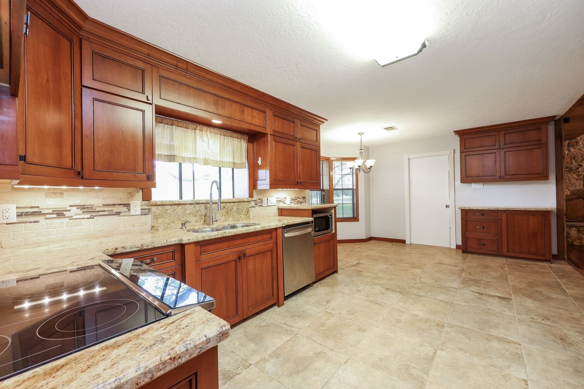 Kitchen with Custom Cabinets, a Double Electric Oven, Pantry Storage, Microwave Shelf has Beautiful Views of the Neighborhood Lake