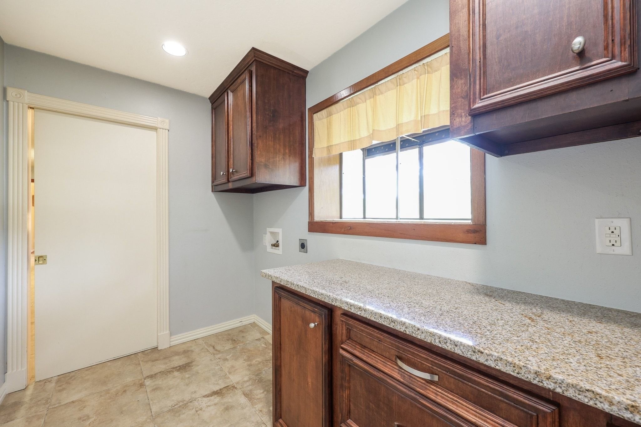The Utility Room with Built-Ins, a Half-Bath, a Storage Closet accommodates a Full-Size Washer & Electric Dryer and Connects to the Attached 2-Car Garage and Breakfast Room/Kitchen.