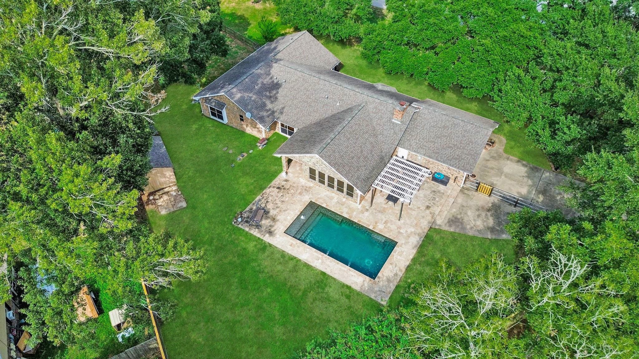 Aerial View of the Home which is Across the Street from the Beautiful Neighborhood Lake with Island.