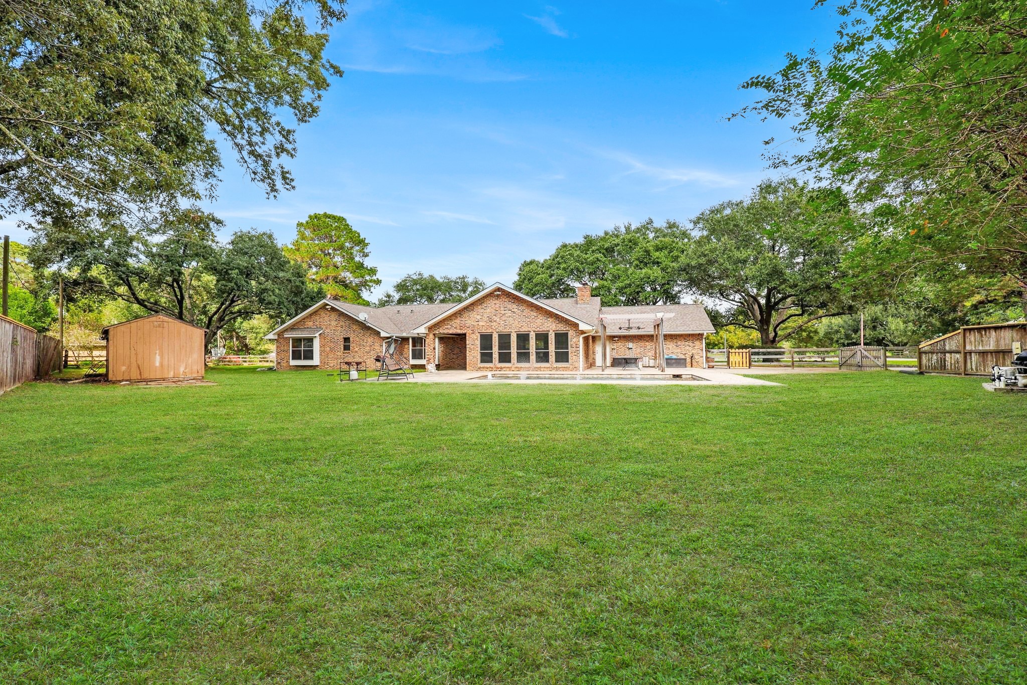 Large, Fully-Fenced Back Yard with Dark Blue In-Ground Gunite Pool with Fountain & Sprays.