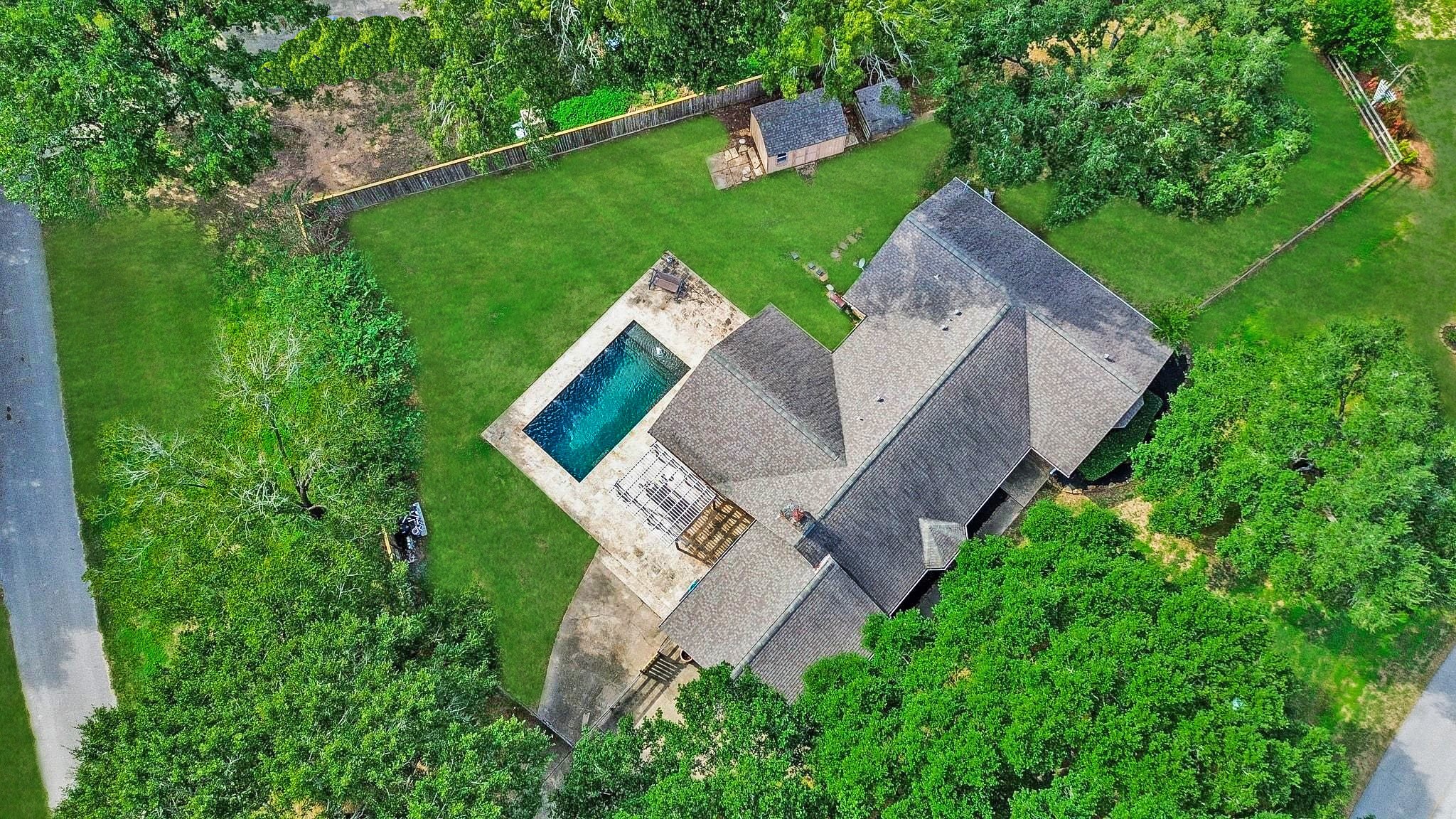 Aerial View of the Home which is Across the Street from the Beautiful Neighborhood Lake with Island.