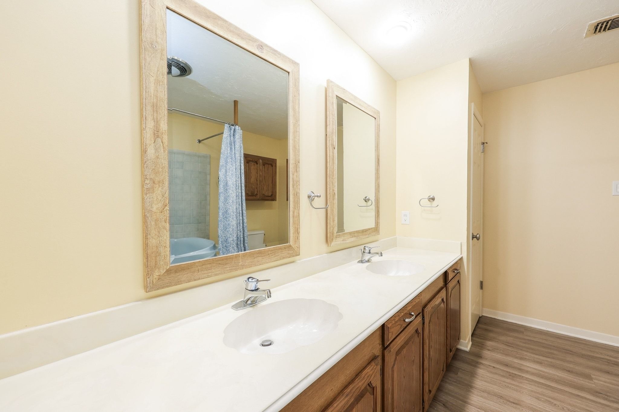 Full Hall Bath with Double Sinks, Toilet Area and Whirlpool Tub/Shower Combo.