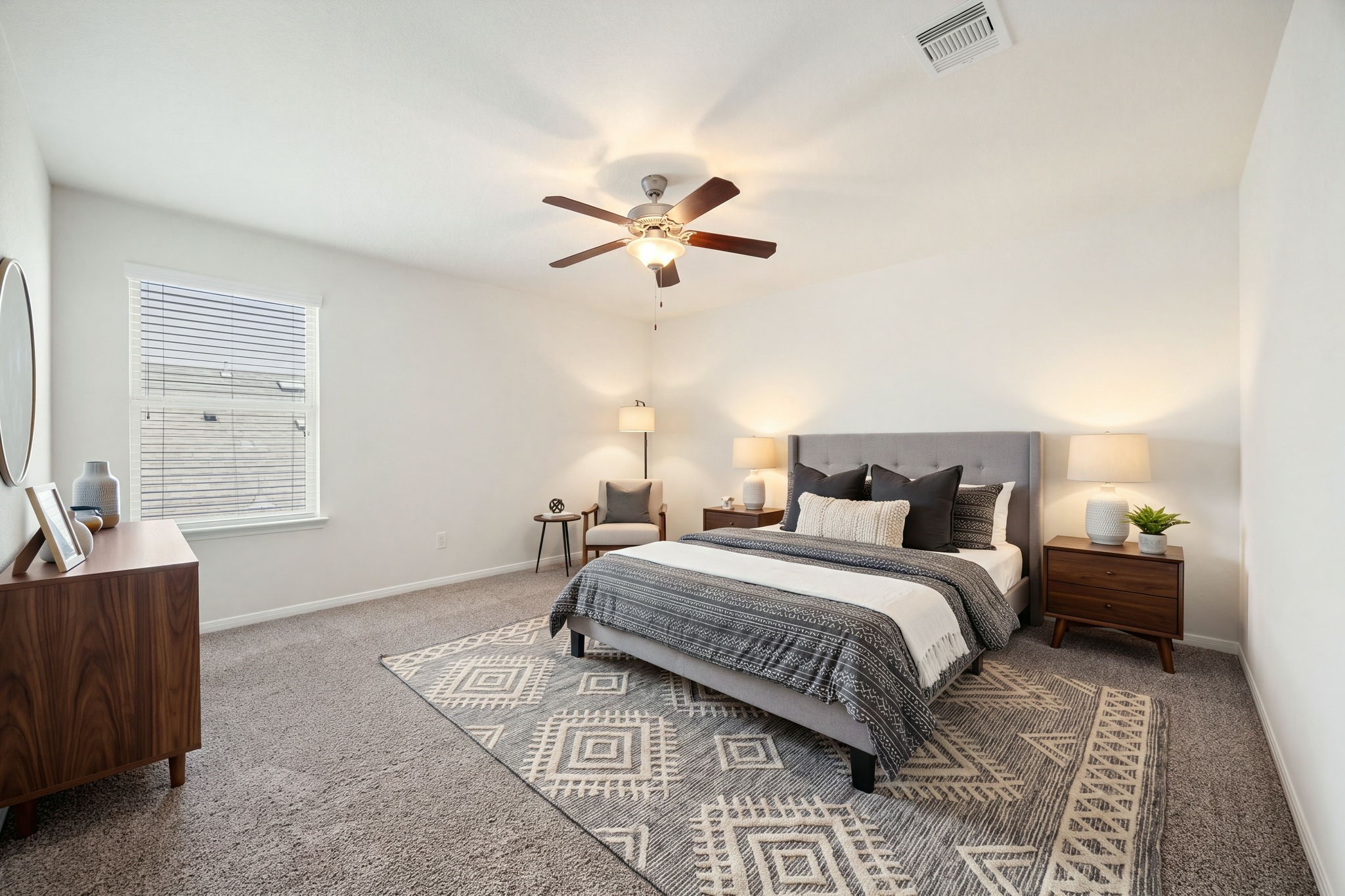Quiet secondary bedroom space featuring a functional layout, plush wall-to-wall carpeting, and a central ceiling fan fixture
