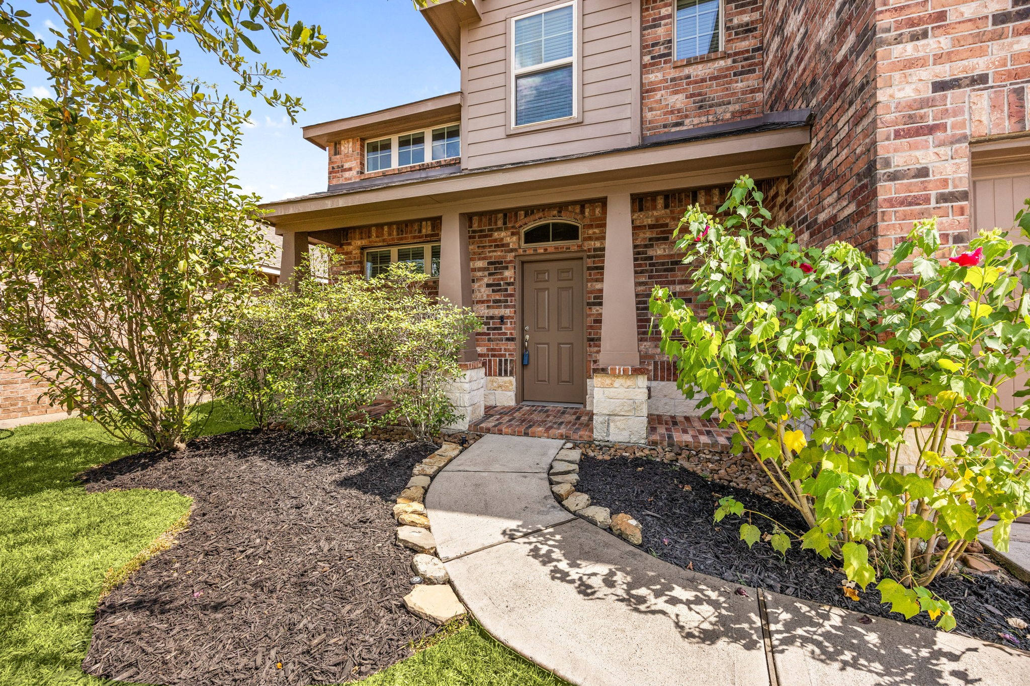 Charming covered front porch with manicured landscaping and a welcoming walkway creates the perfect first impression and a warm place to relax and enjoy the neighborhood.