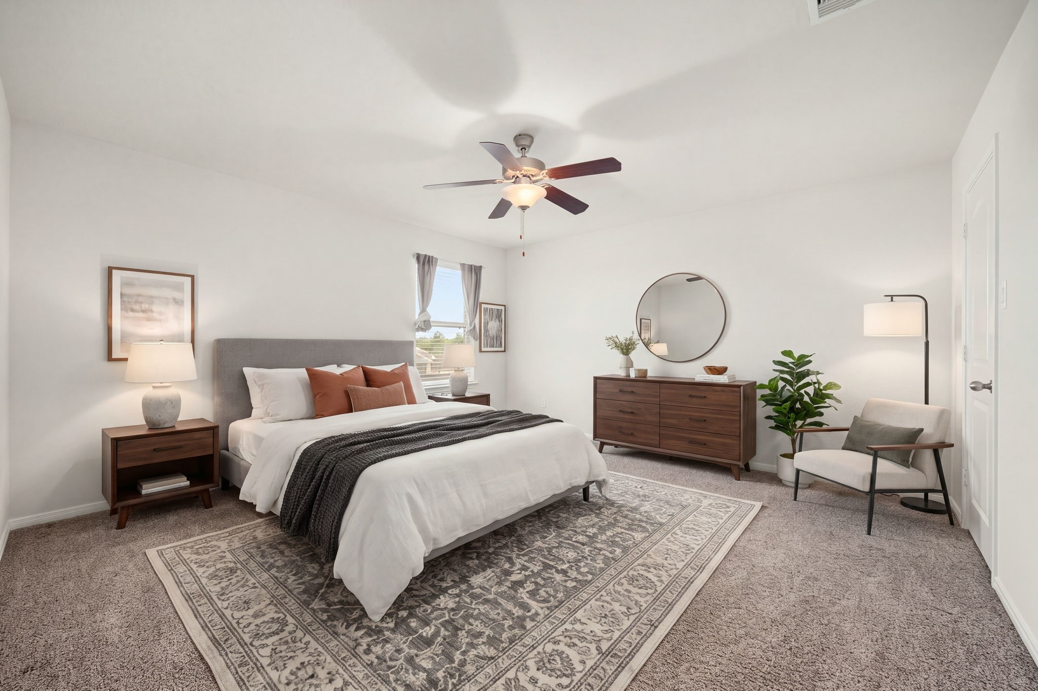 Comfortable secondary bedroom offering a clean-lined layout, warm plush carpeting, and a central modern ceiling fan.