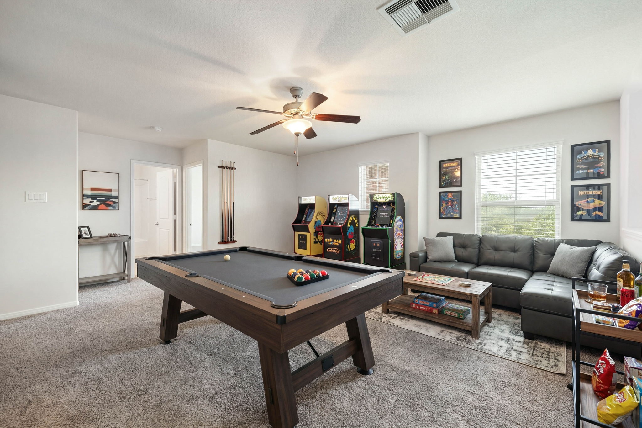 Versatile second-floor loft and game room featuring an expansive layout, plush carpeting throughout, and excellent natural light.