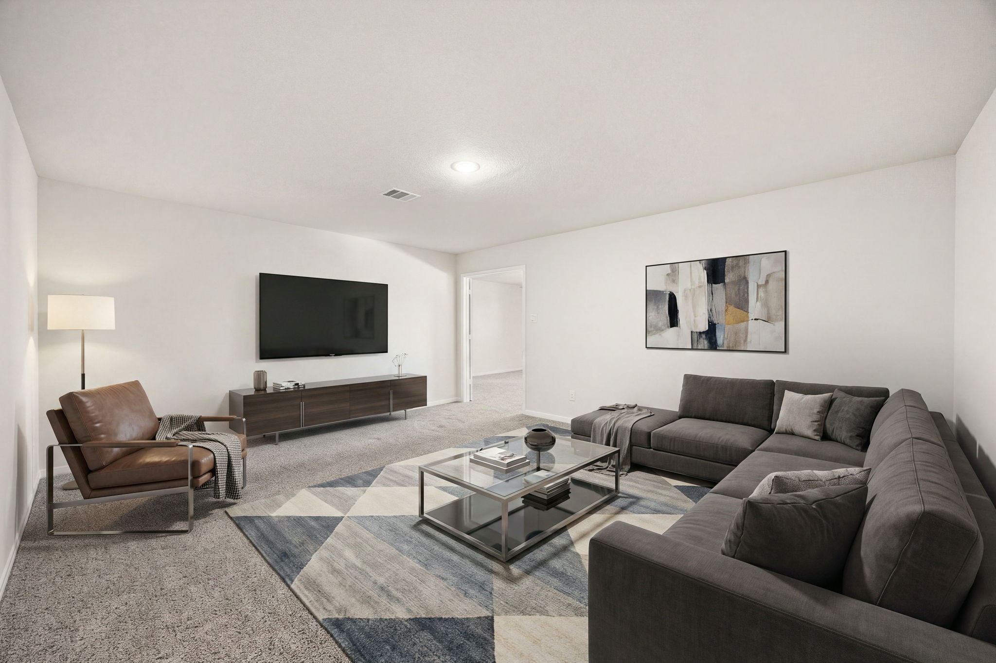 Dedicated media room or flexible home theater space featuring a windowless design for optimal light control and deep plush carpeting.