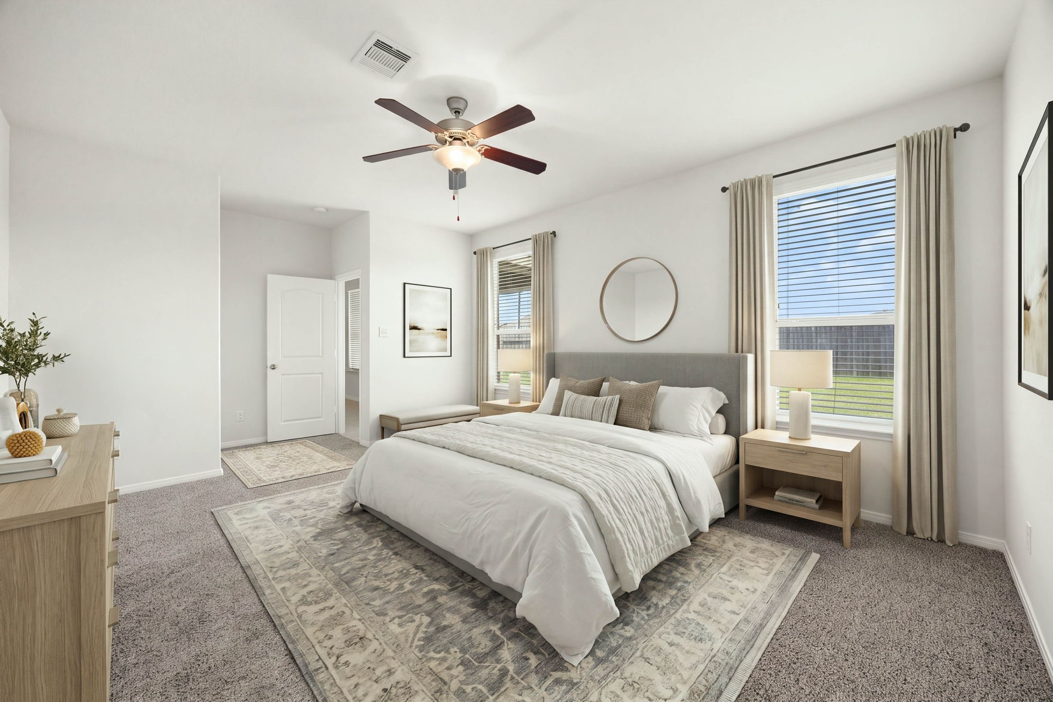 Serene primary bedroom suite showcasing plush carpeting, dual oversized windows, and a large walk-in closet entry.