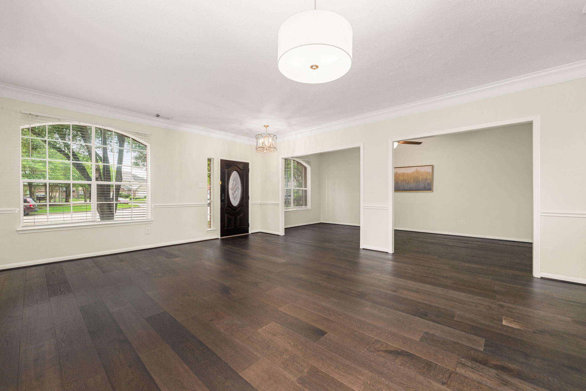 Welcoming entry opens to a bright layout with formal dining on the right and flexible space on the left.
