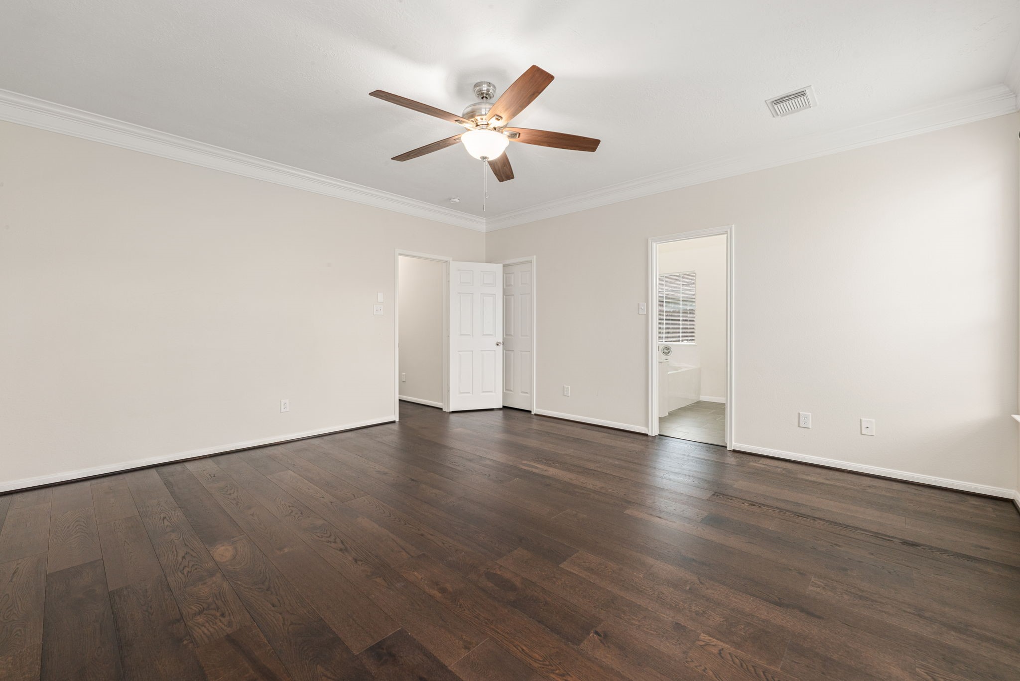 Primary suite tucked away for privacy with a relaxing and spacious layout.