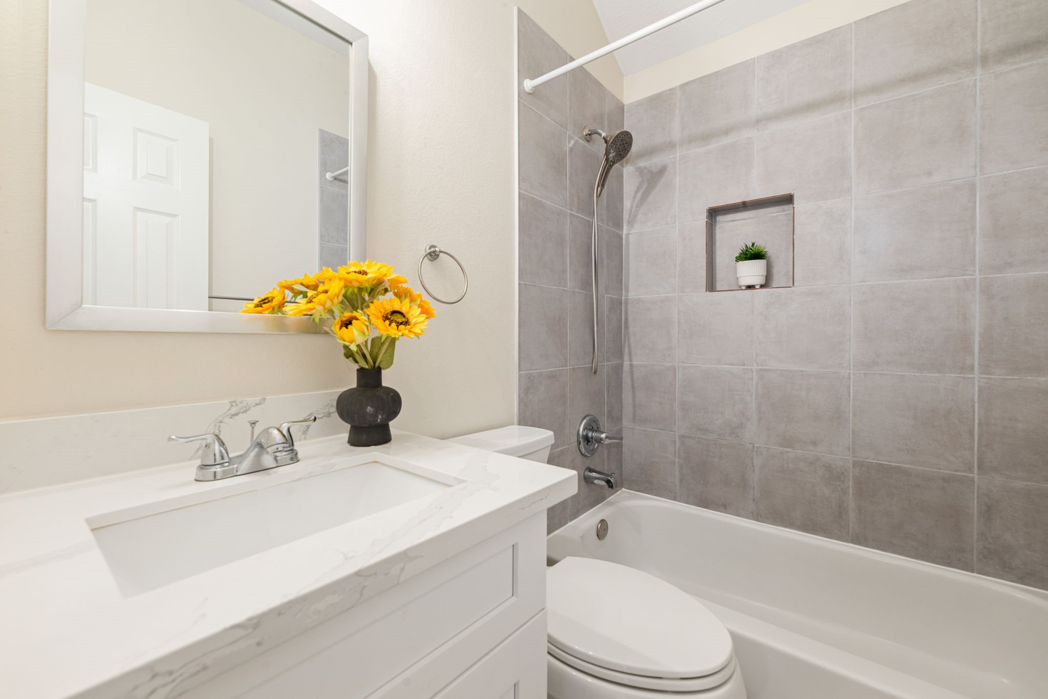 Upgraded bathrooms with modern vanities, quartz counters, and updated fixtures.