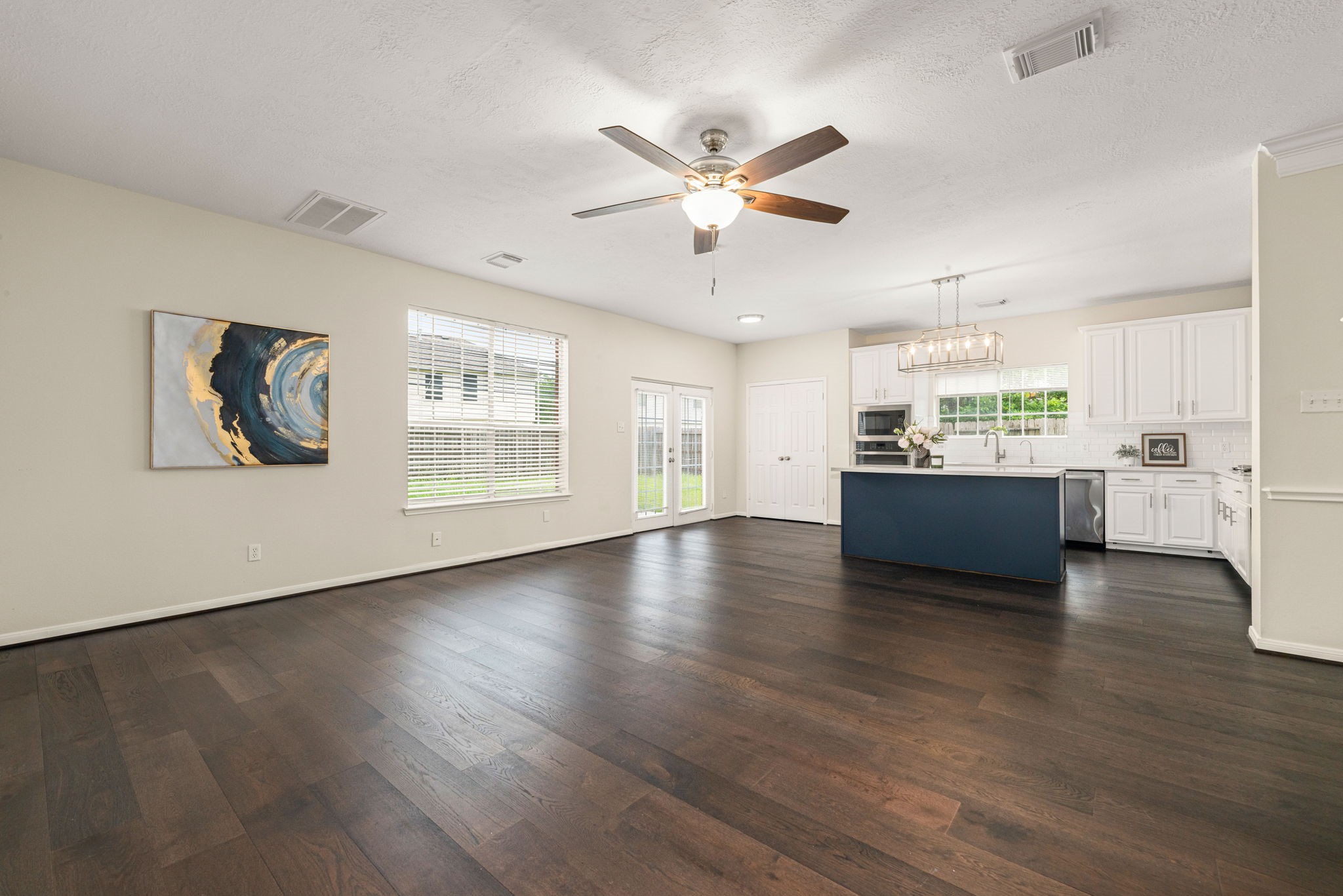 Spacious living room filled with natural light and a cozy gas fireplace as the focal point.