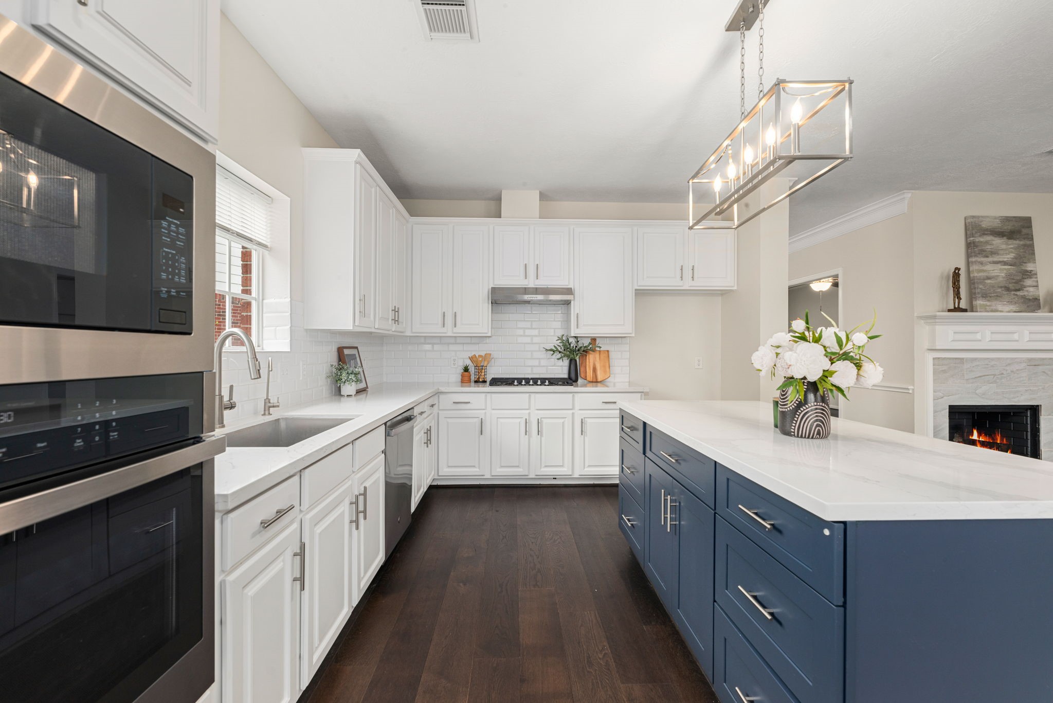 Gourmet kitchen featuring a new island, quartz countertops, and stainless steel appliances.