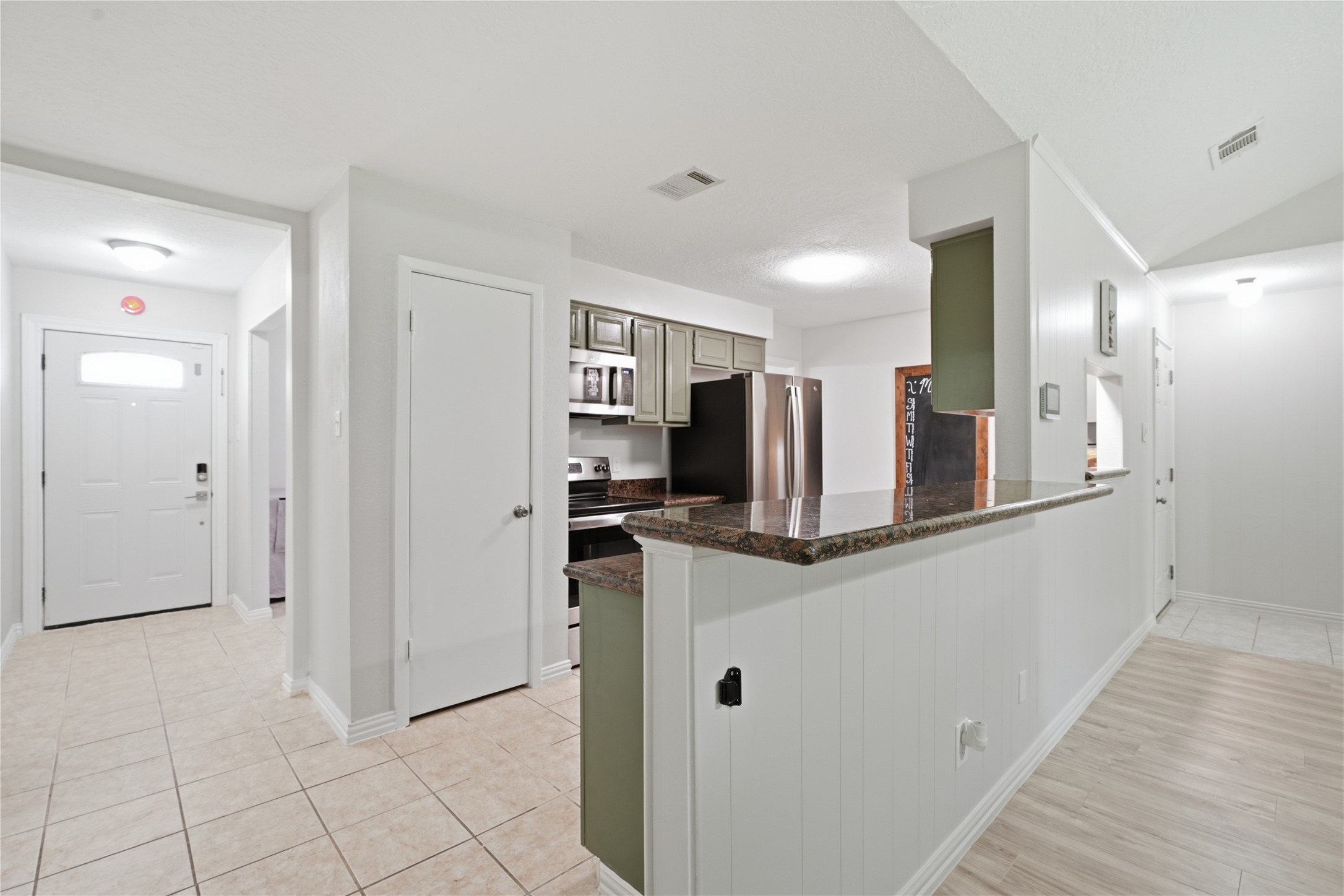 Open kitchen with an elevated breakfast bar, granite countertops, and easy flow into the main living areaideal for everyday living and entertaining.