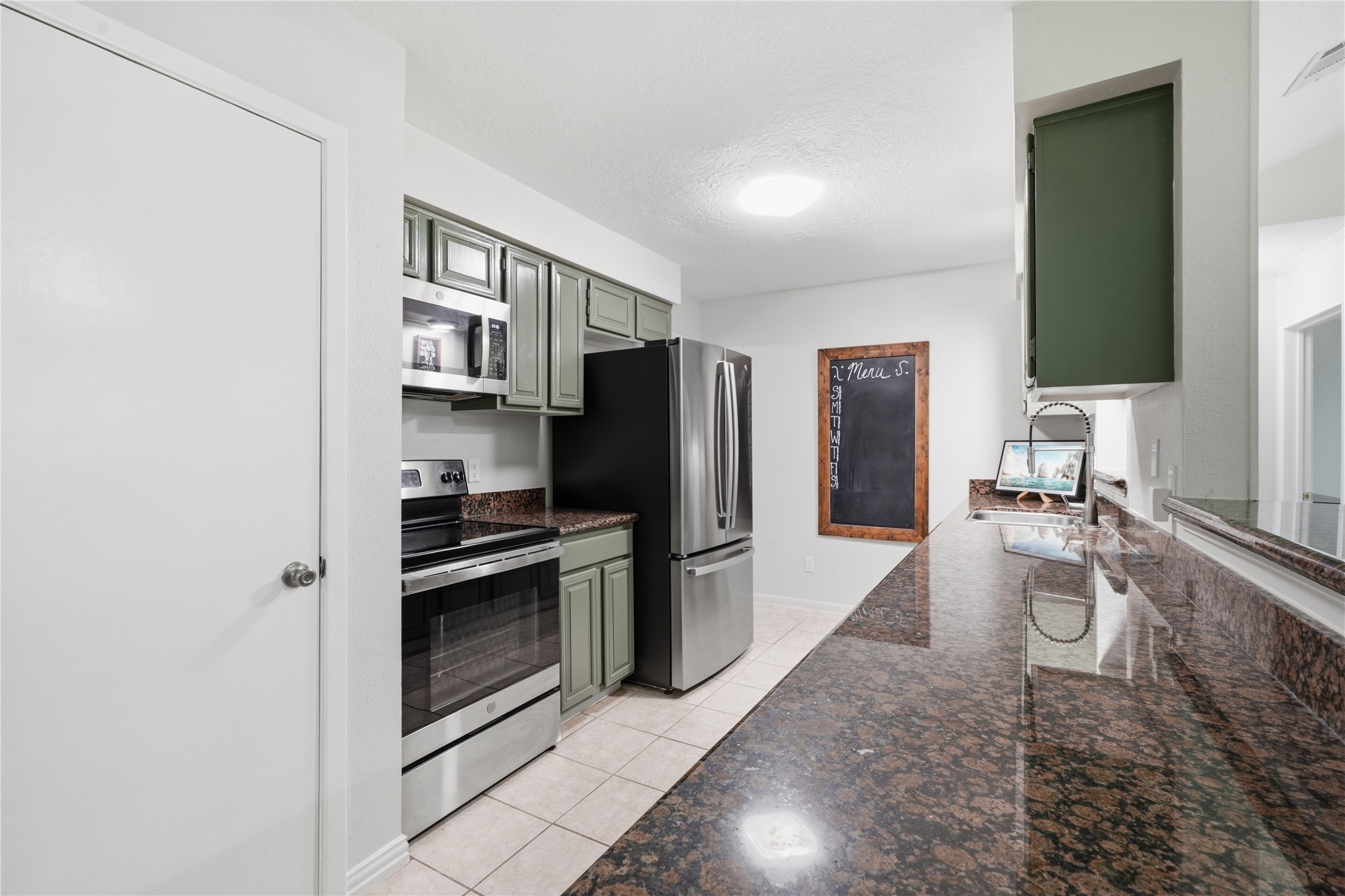 Functional kitchen layout with abundant storage, expansive work surfaces, and easy access to both the dining room and living room. Functional kitchen layout with abundant storage, expansive work surfaces, and easy access to both the dining room and living room.