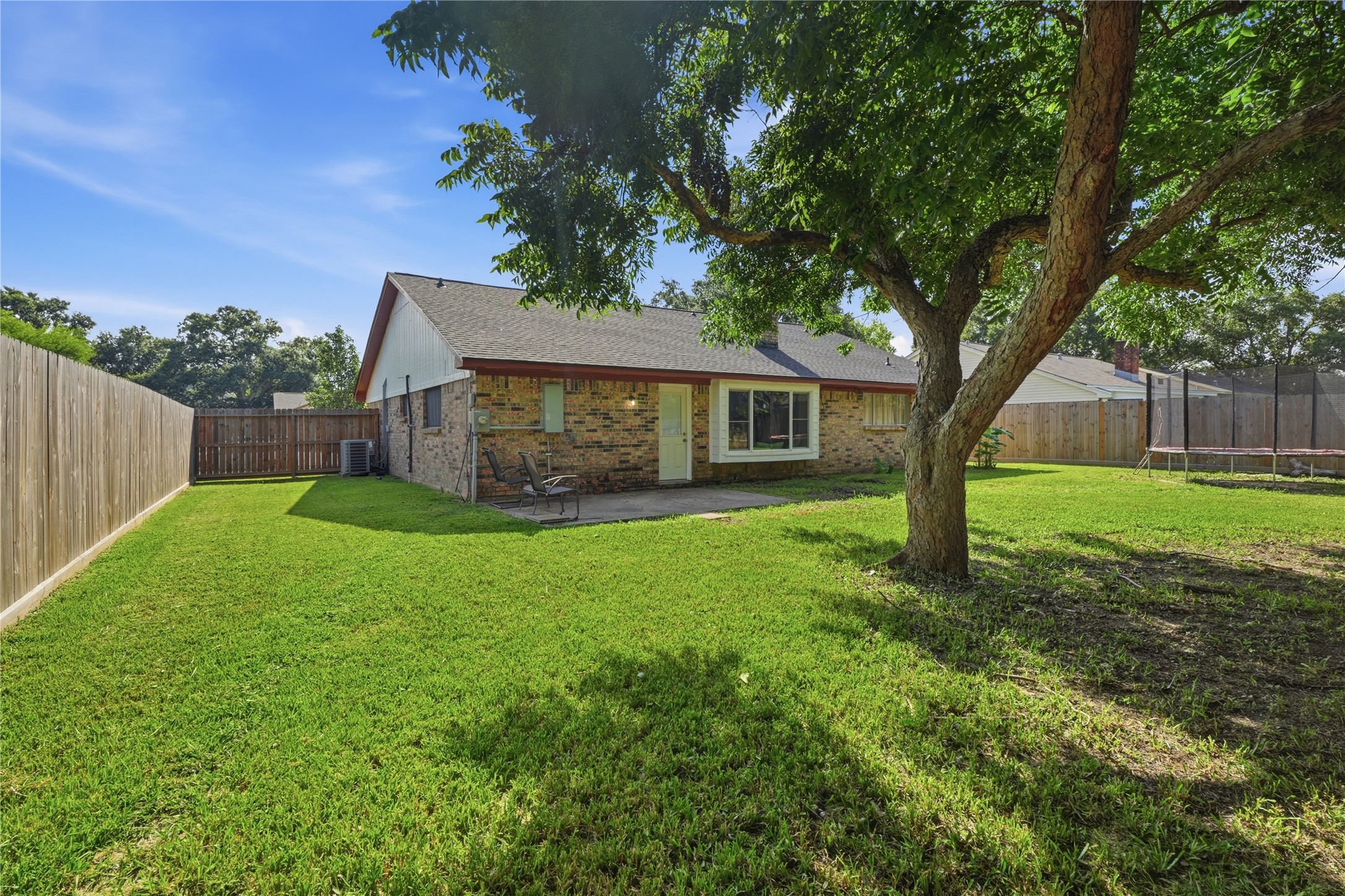 Enjoy a generous backyard complete with mature trees, a covered patio, and gated side-yard access.