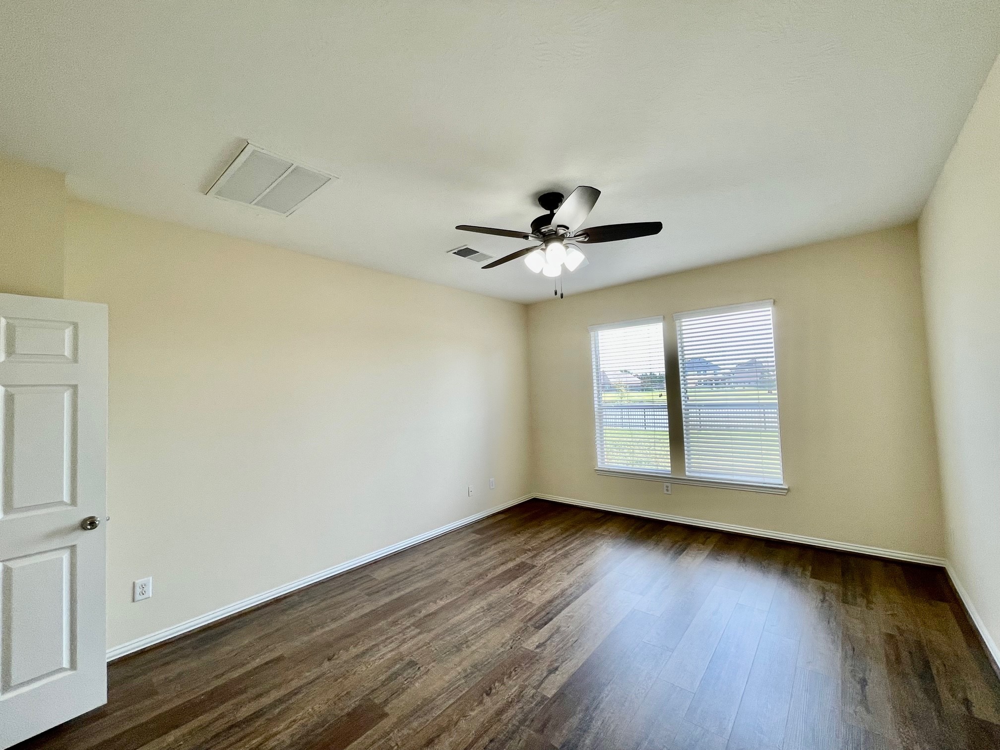 Primary master bedroom downstairs with new wood-liked floor