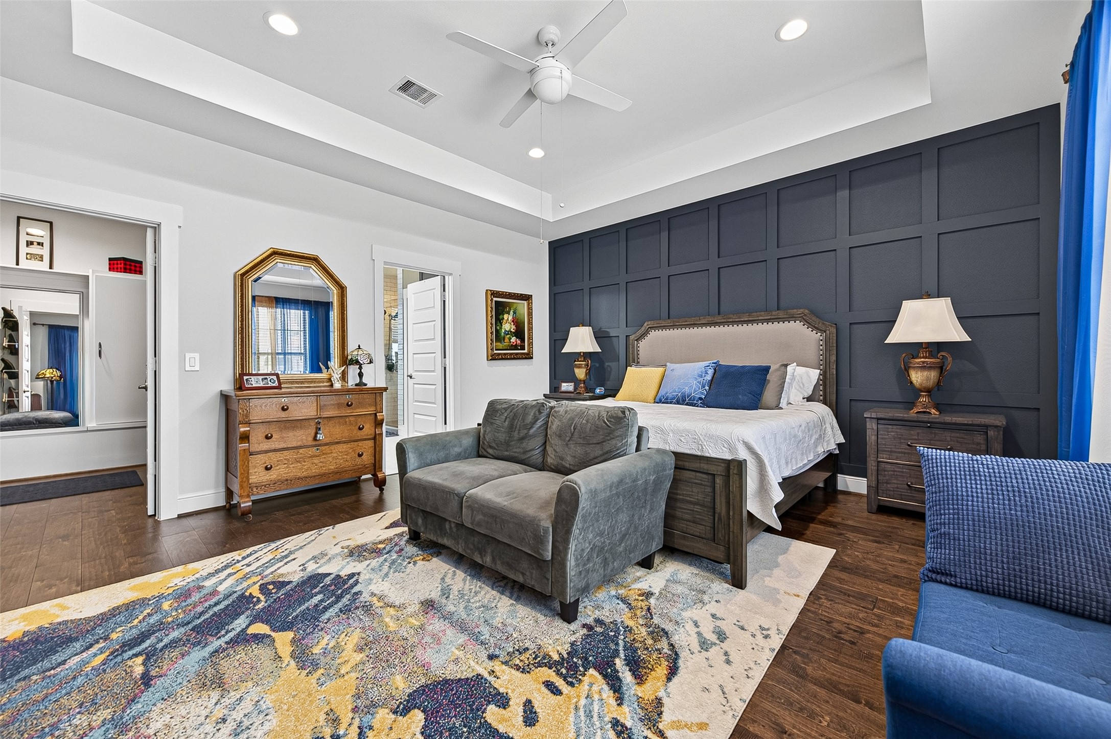 Enter into the Primary Suite.  Designed to impress with the Tray Ceiling and the Distinctive Accent Wall. The spacious room folds into the stunning en suite bath for a luxurious experience.  On the left is the Primary Closet.