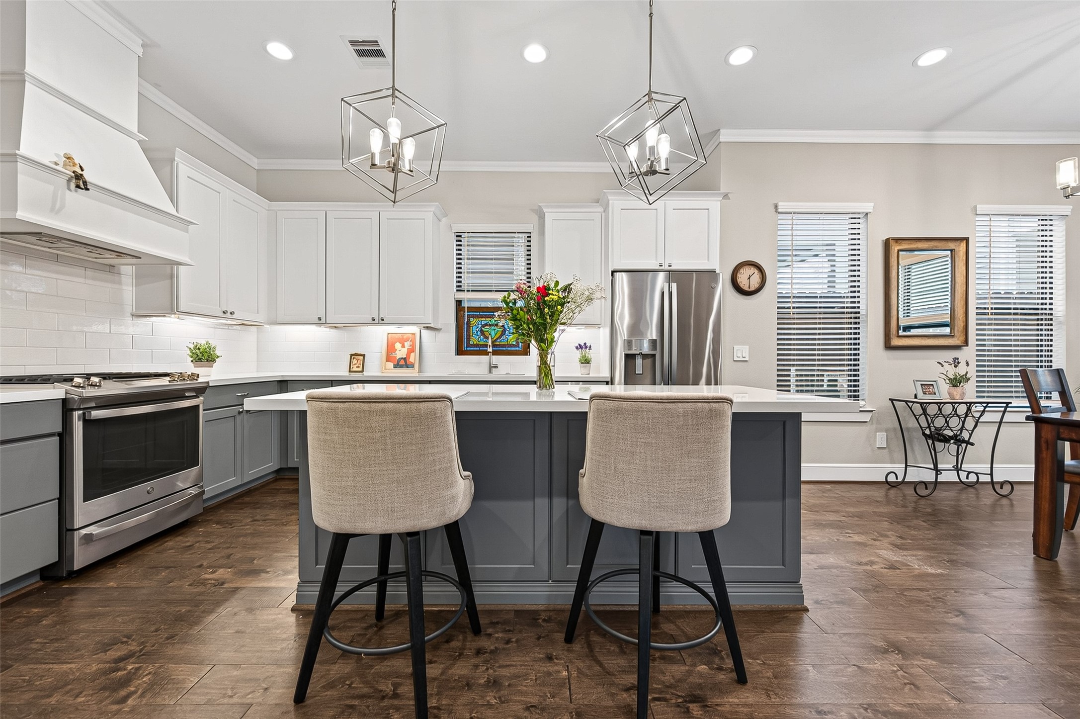 Plenty of recessed lighting in the home with dimmer switches throughout. The engineered hardwood flooring provides an attractive contrast to the wall and cabinet colors.
