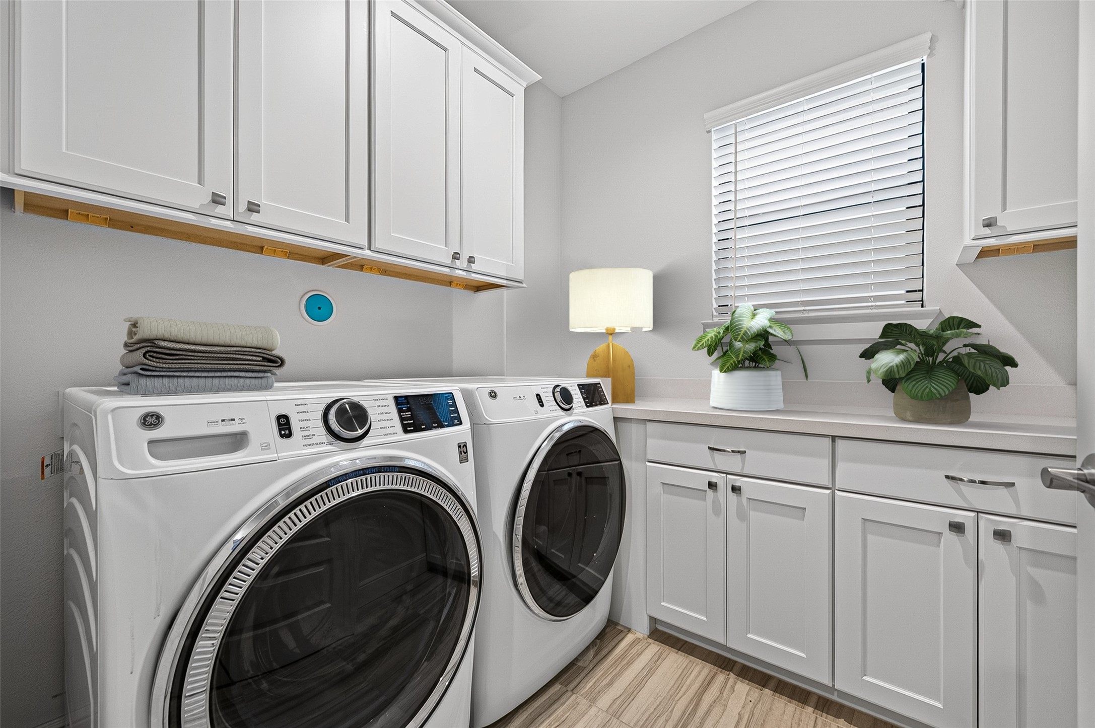 The perfect place for a Laundry Room is near the bedrooms.  Convenience with Design.  Natural light, a folding counter and plenty of storage.