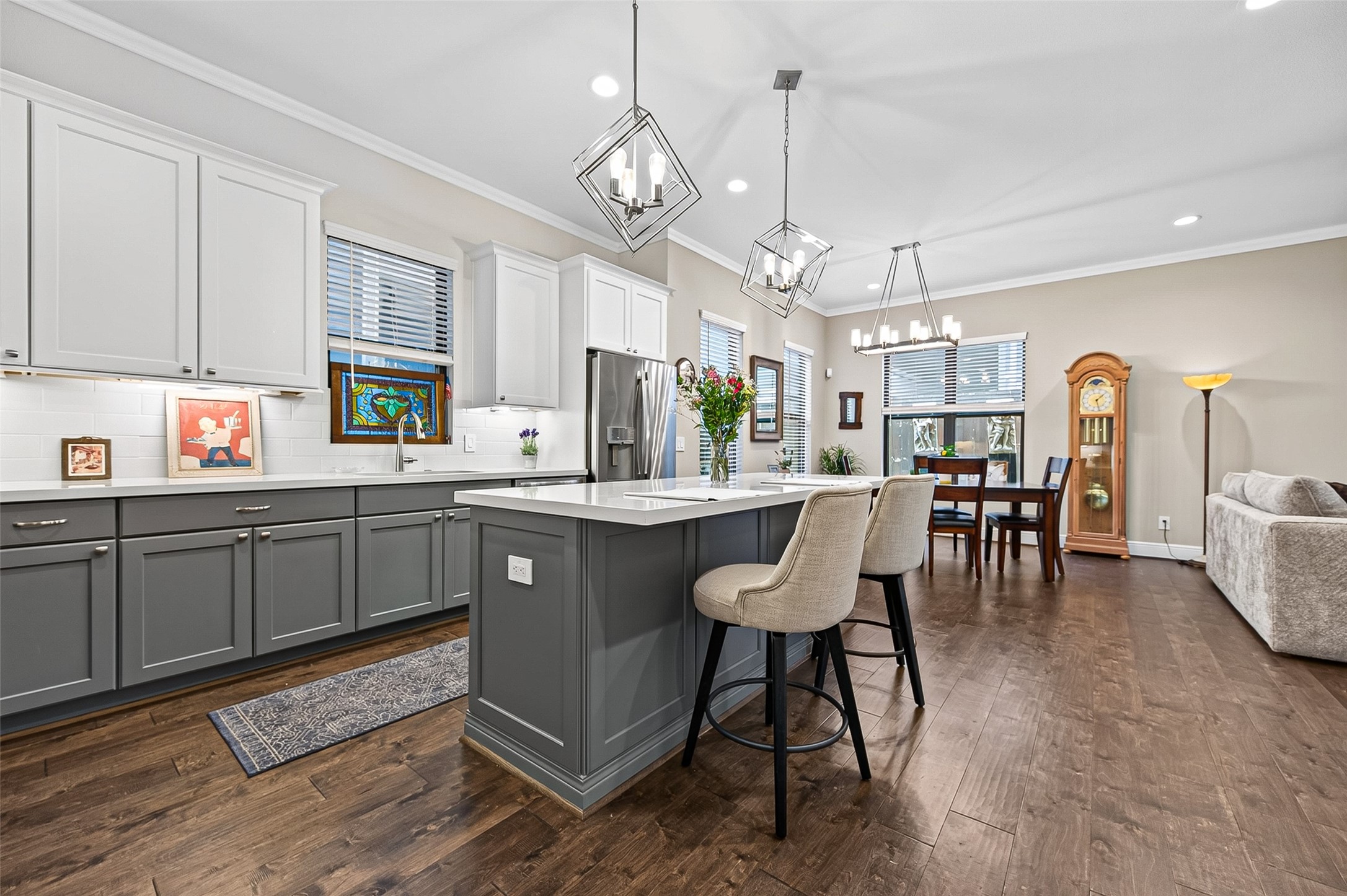 The pendant lighting adds another level of design with it's geometric shape. Note the longer windows that allow natural light into the main level "great space".
