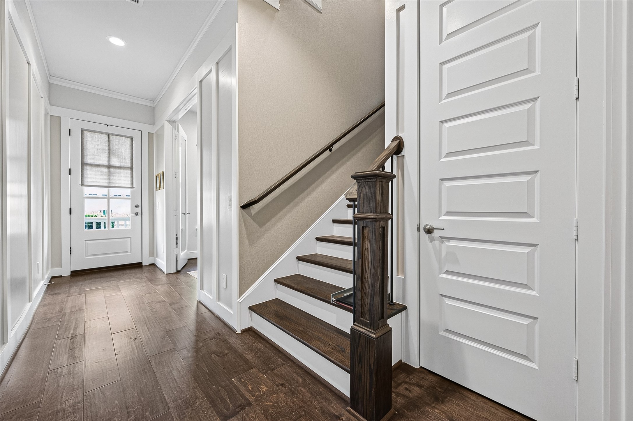 A little further down from the Home Office are the extra-wide stairs leading to the bedrooms, laundry room and second living space/gameroom. Behind the door to the right of the stairs is an L-shaped Interior Storage Closet with custom shelves added by the owner.
