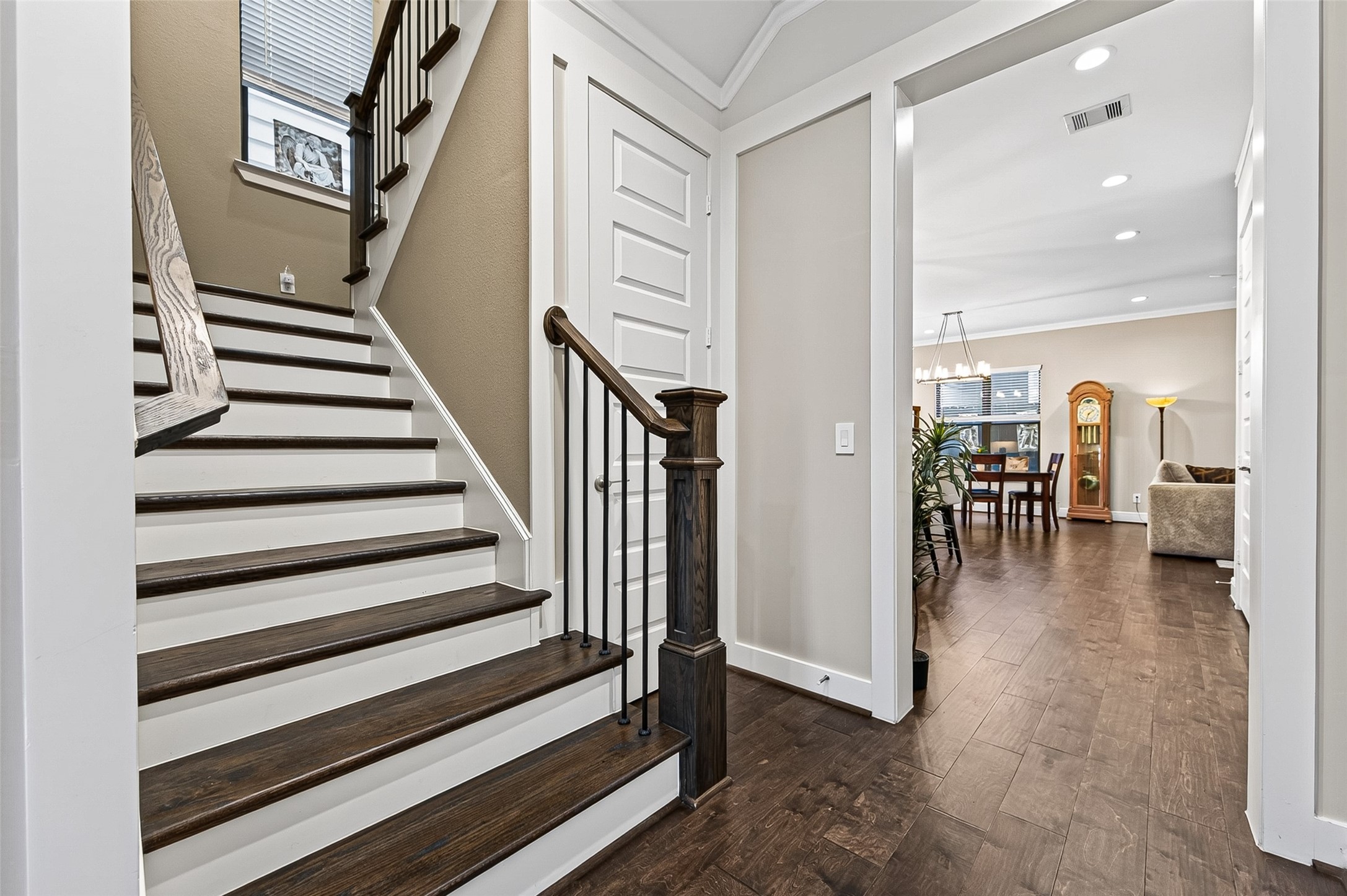 Beyond the stairwell you see the entrance to the kitchen, dining, living areas.  Natural light throughout the home, even in the sectioned stairwell.