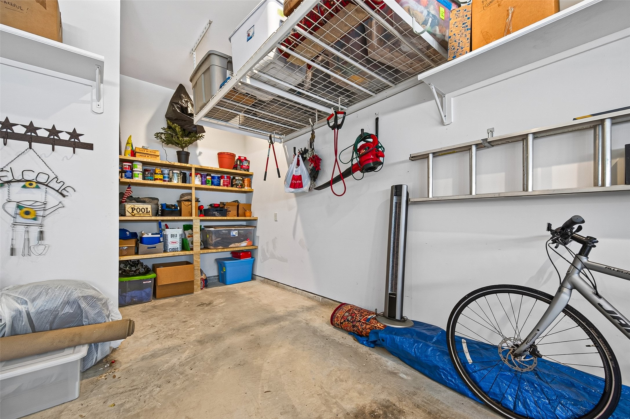 Oversized double garage with high ceilings tout the custom storage features the owner added.  A great designer look to bring finesse to this space.