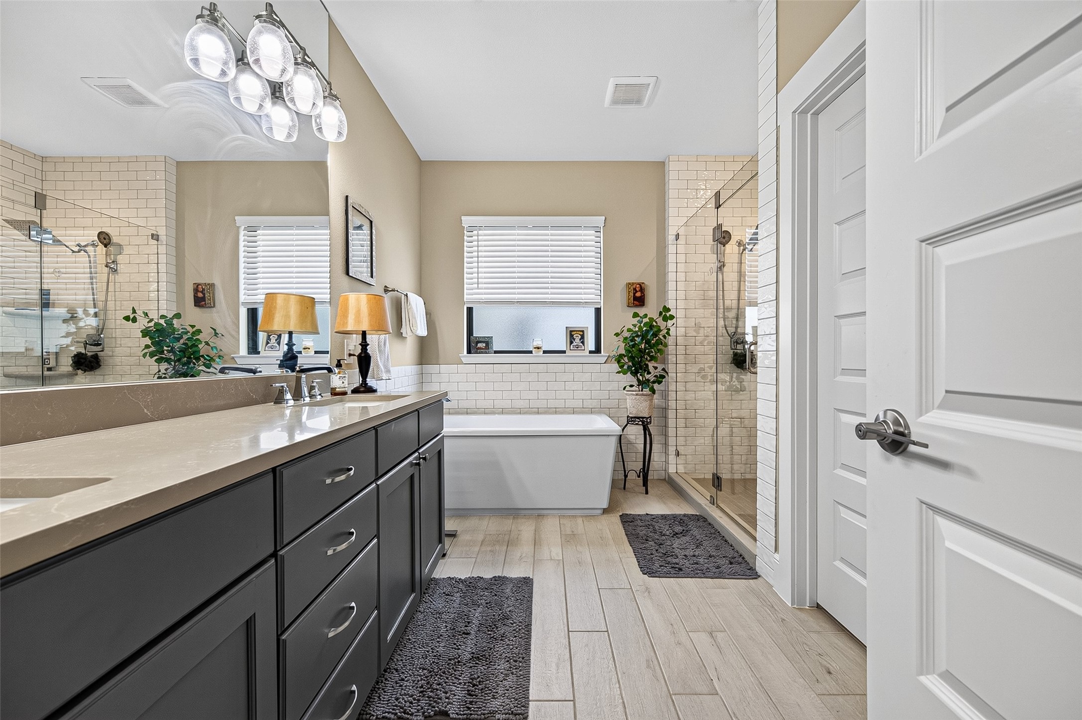 Enter into this pretty bathroom designed with all the amenities and ample space to enjoy your private place.  Double sinks, soaking tub, spa-like shower, water closet and plenty of storage.