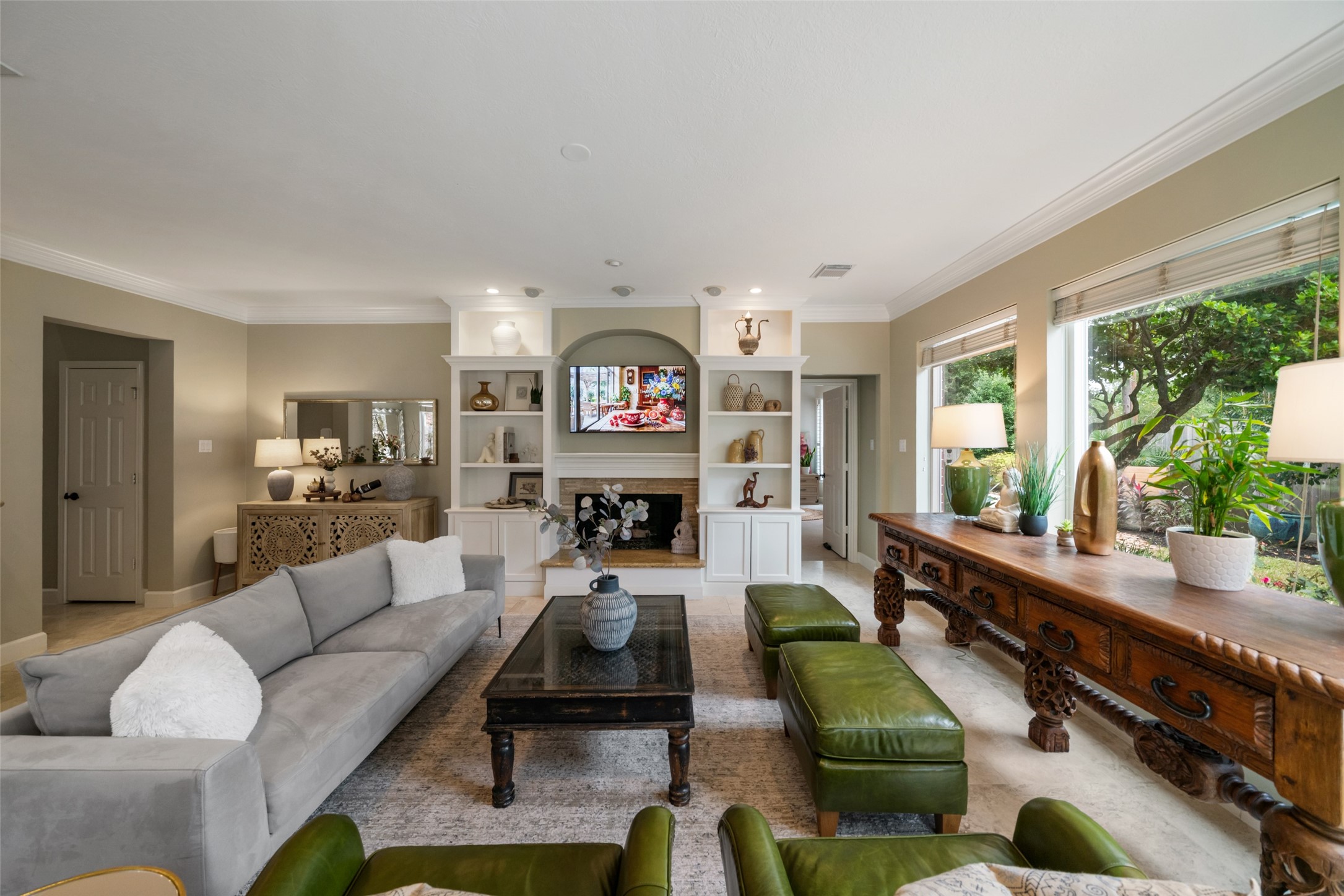 Primary bedroom is privately located near the back of the home with pool views.