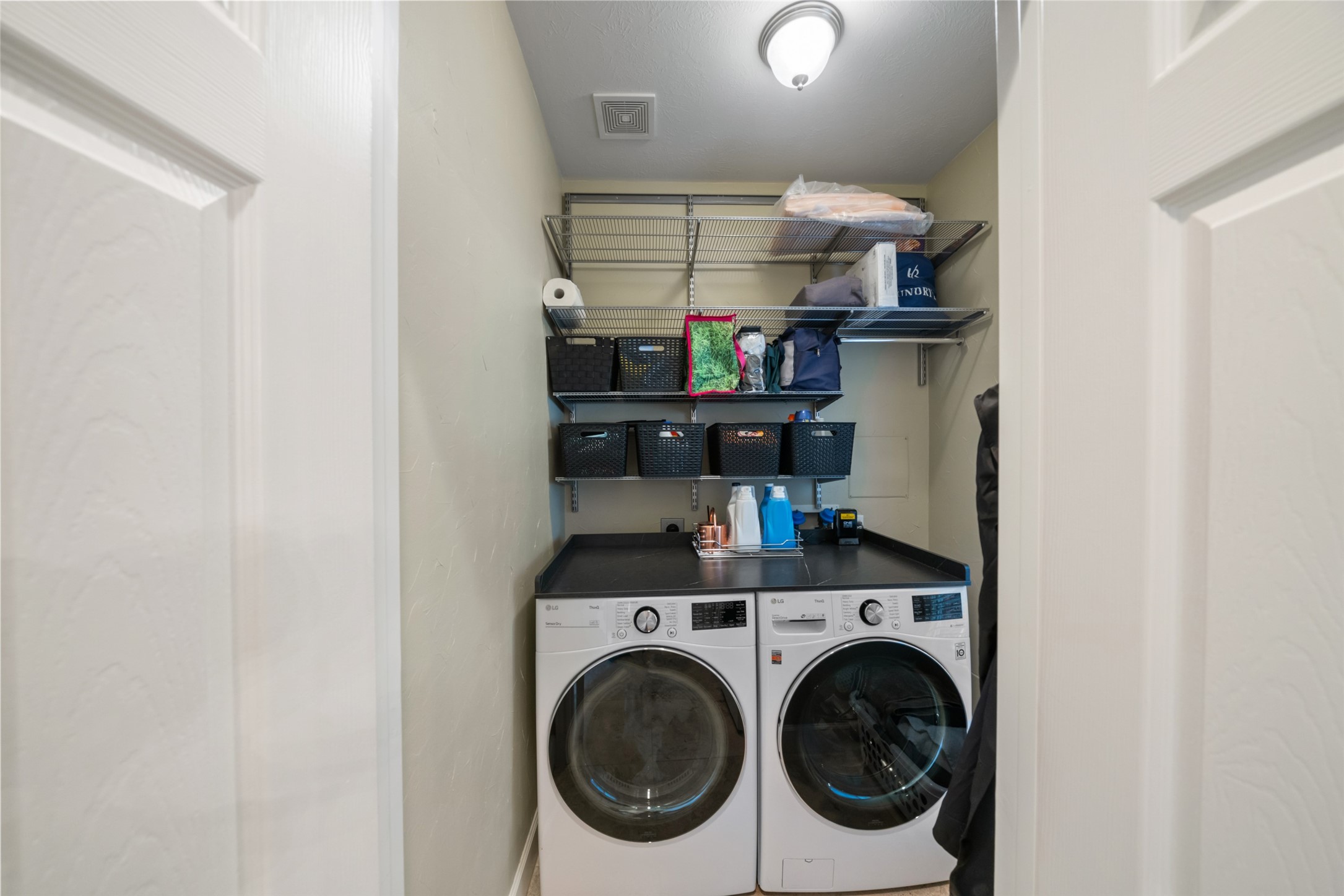Utility room inside the home including a shelving system.