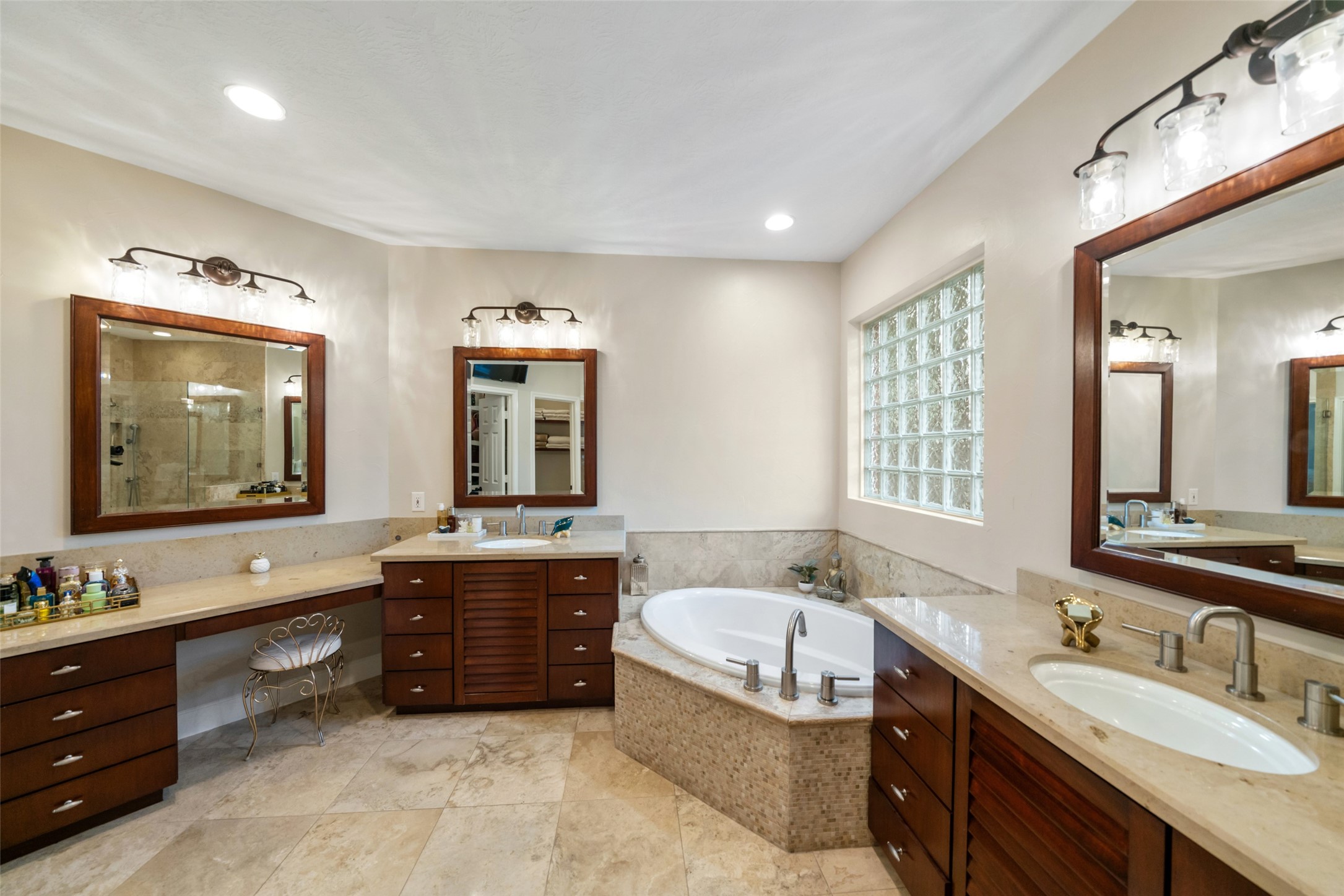 Double sinks and a vanity. Soaking tub plus a stand-up shower. This home incorporates all the solutions to your needs. An additional walk-in closet is also included.