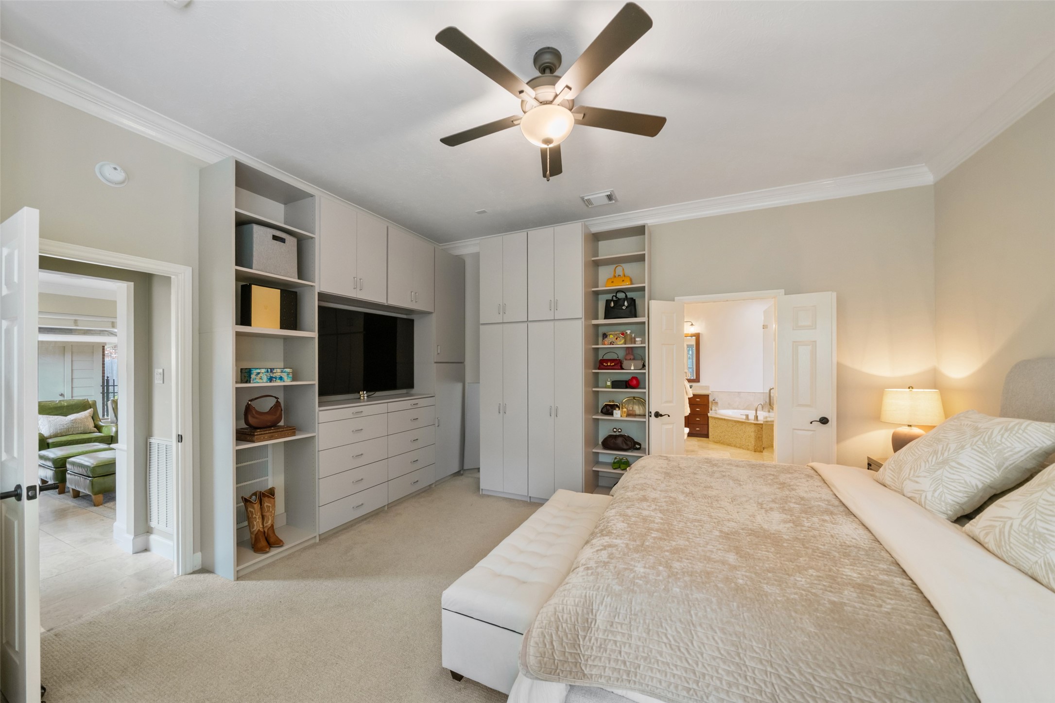 The primary bedroom boasts a closet system installed by, Closets By Design.