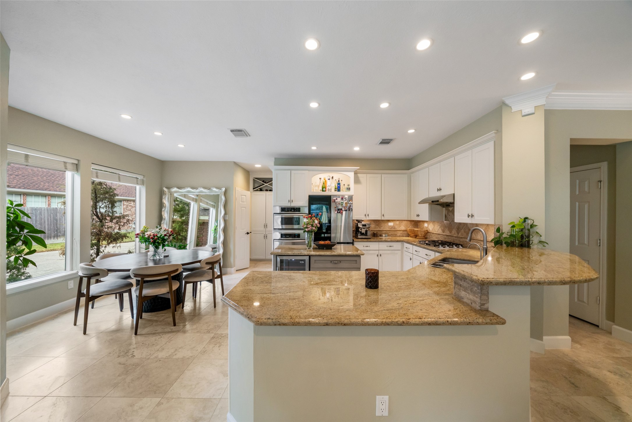 Extremely functional kitchen with breakfast nook and high bar.