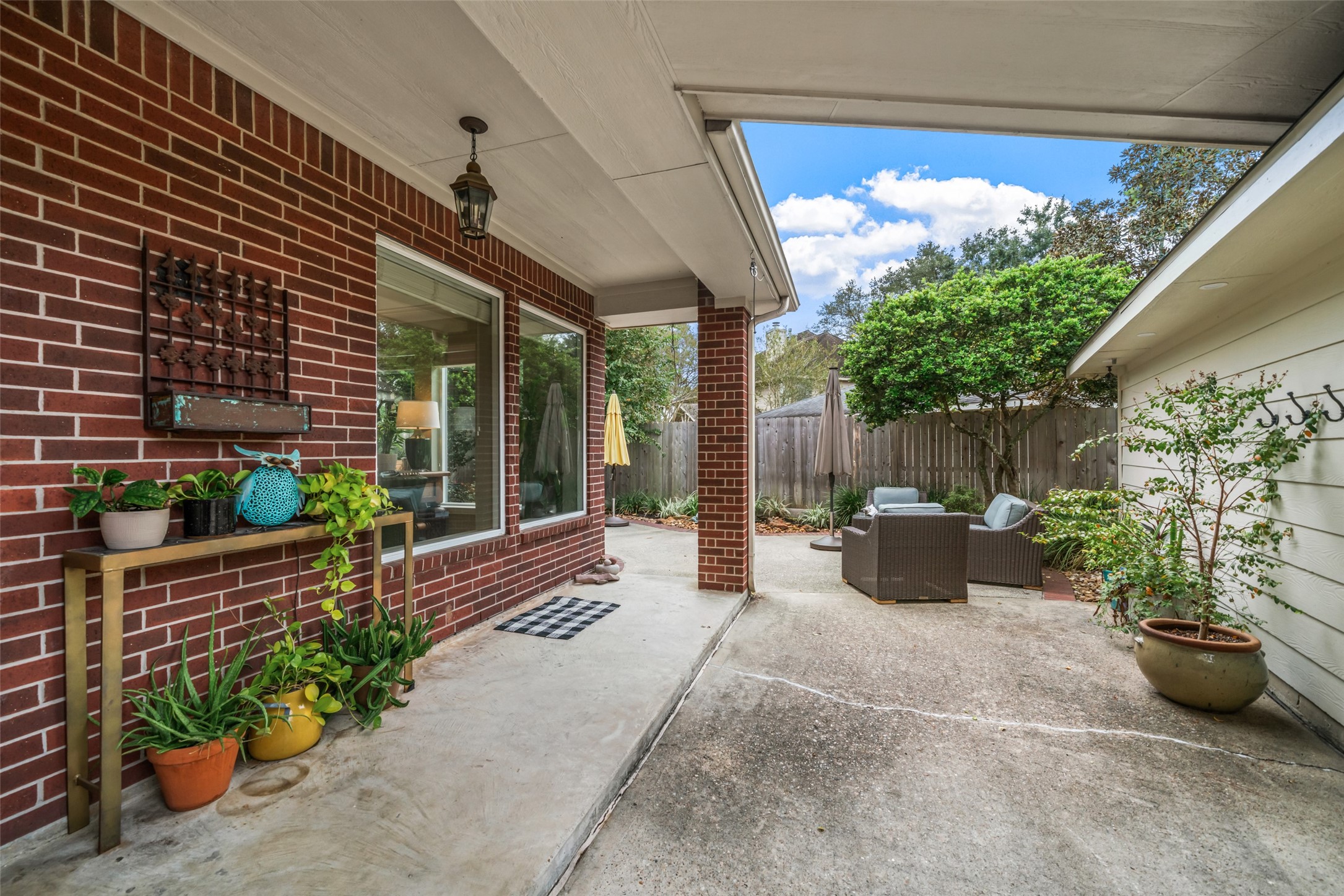 This is the backdoor view from the kitchen. The covered walkway connects the garage and leads to the outdoor oasis.