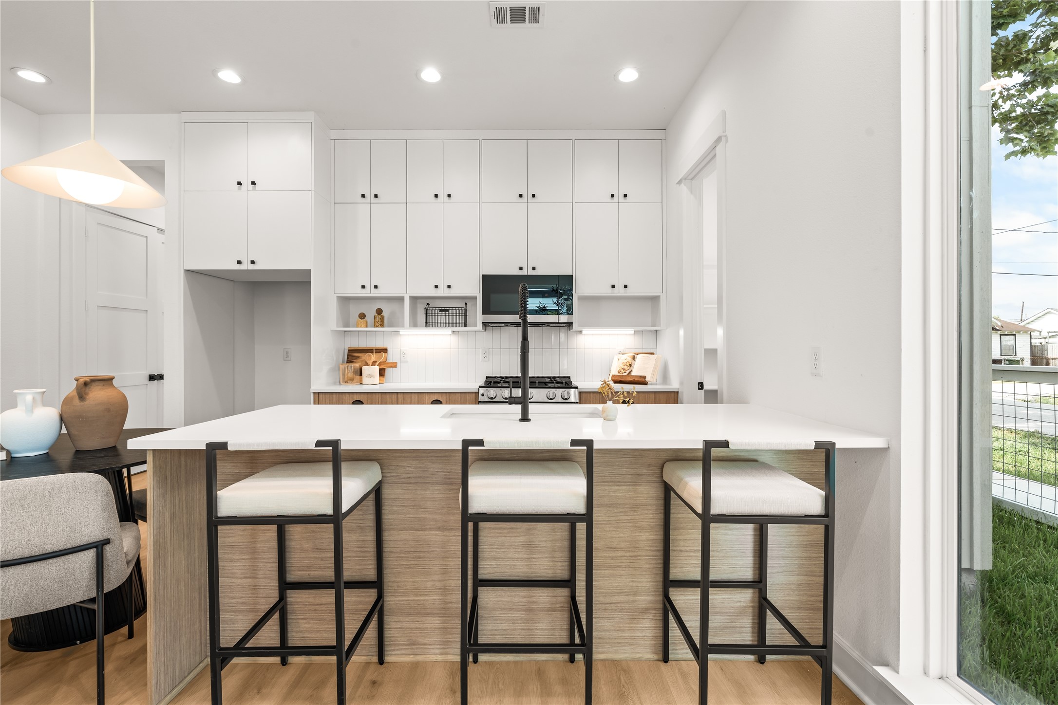 Kitchen island with breakfast bar seating the anchor of a main floor built for real life Kitchen island with breakfast bar seating the anchor of a main floor built for real life