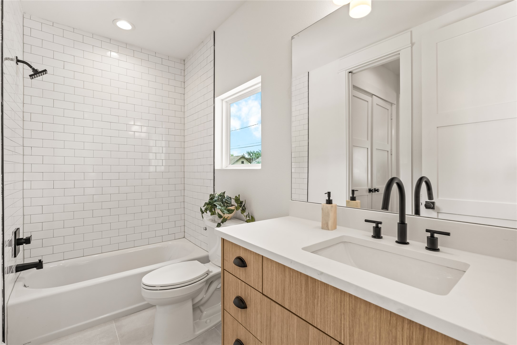 First-floor full bath  three full baths in this home, matte black hardware, tiled shower