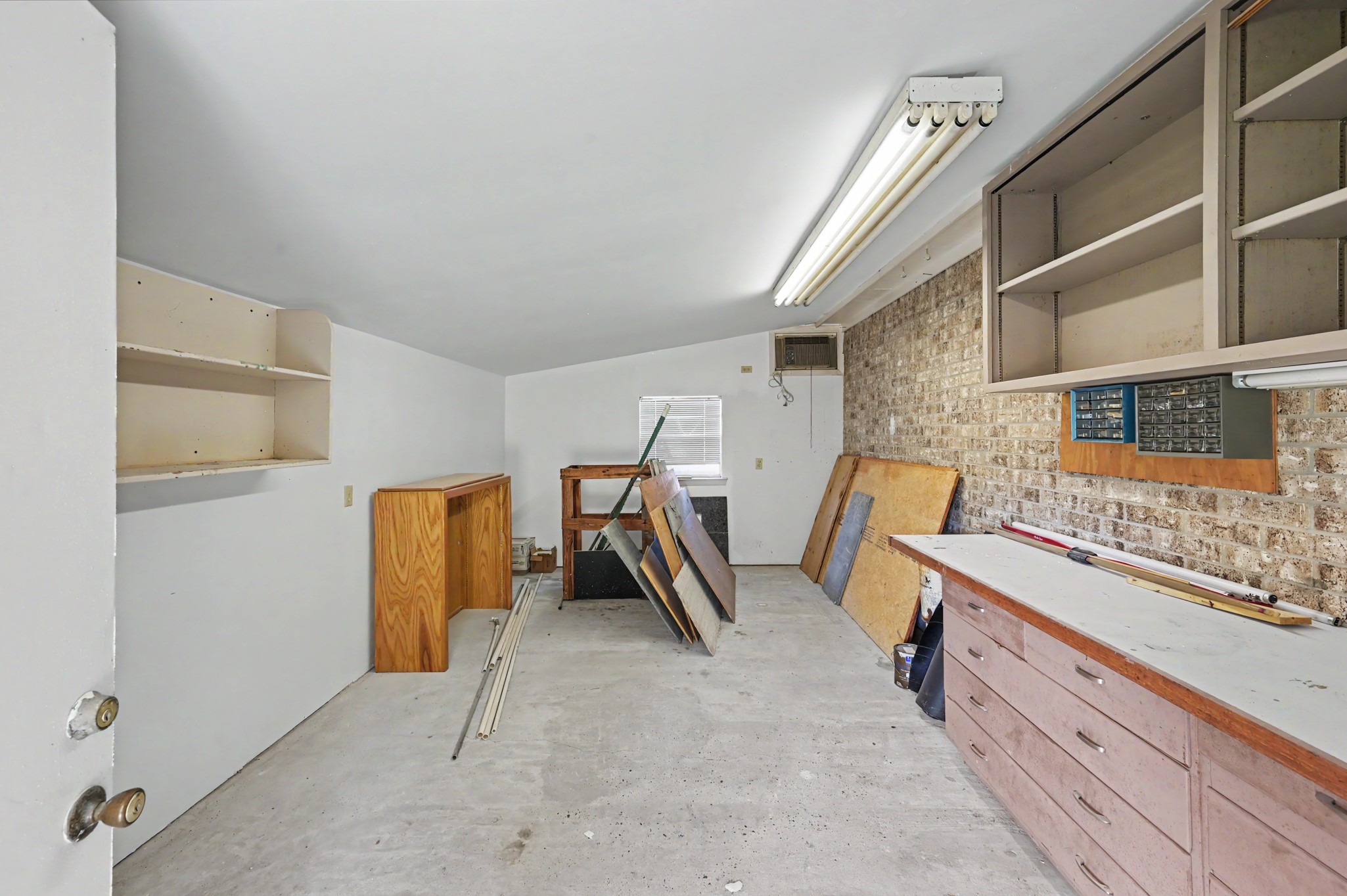 Spacious workshop with ample storage, ideal for projects and organization.